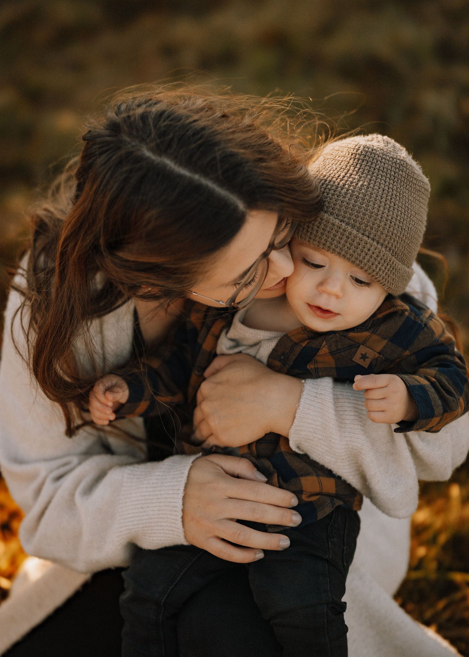 A tender moment between parent and child during golden autumn light.