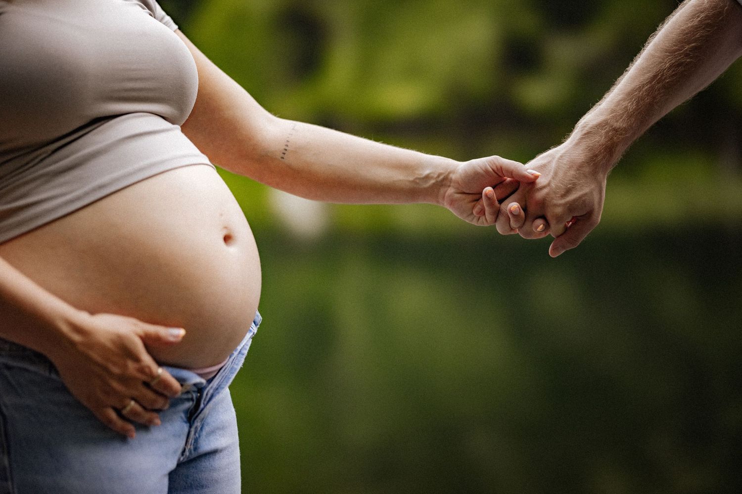 Close-up shots of pregnant belly with hands showing loving connection.