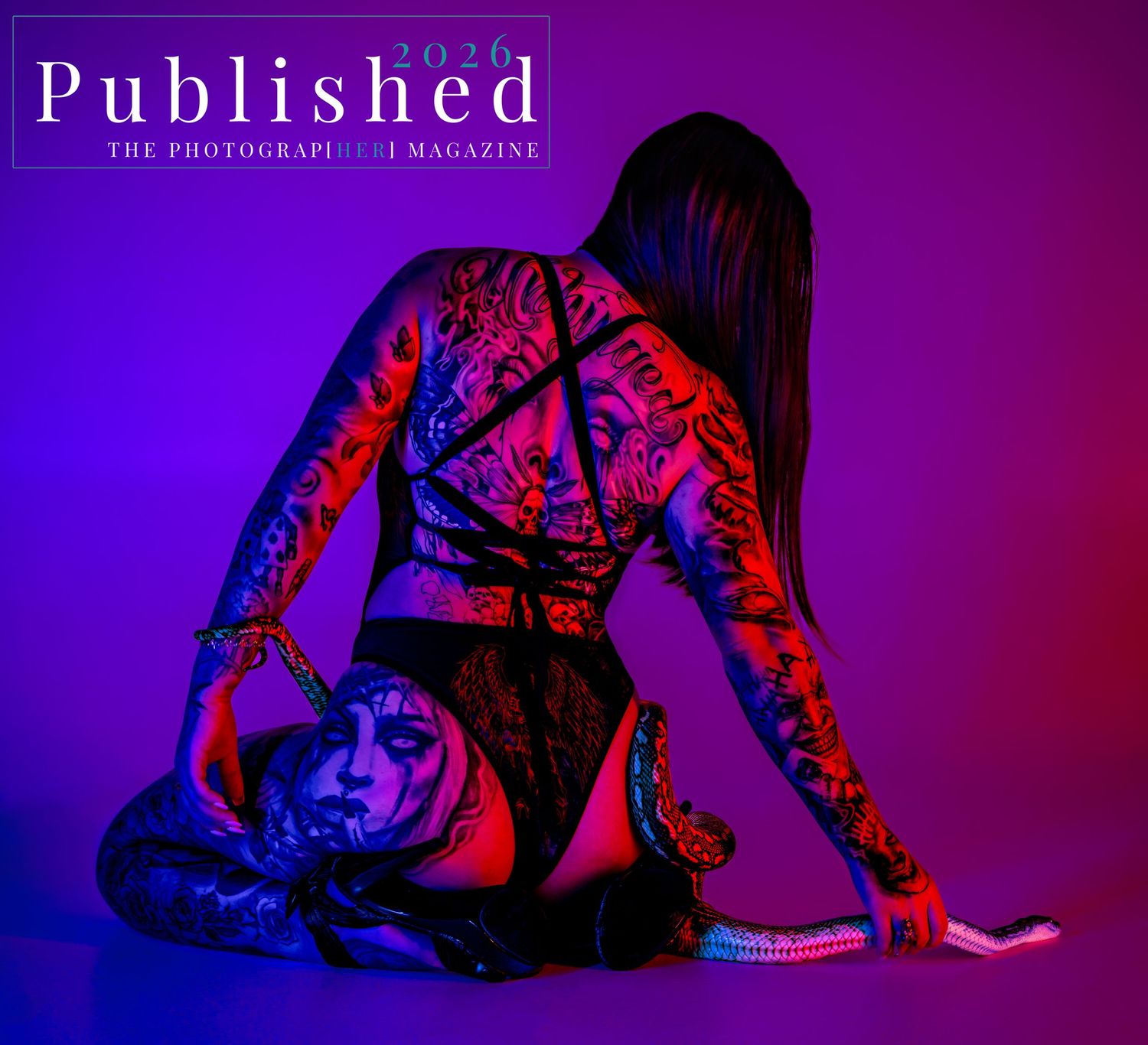 A heavily tattooed woman poses in purple and red lighting on the cover of Published 2026 photography magazine.