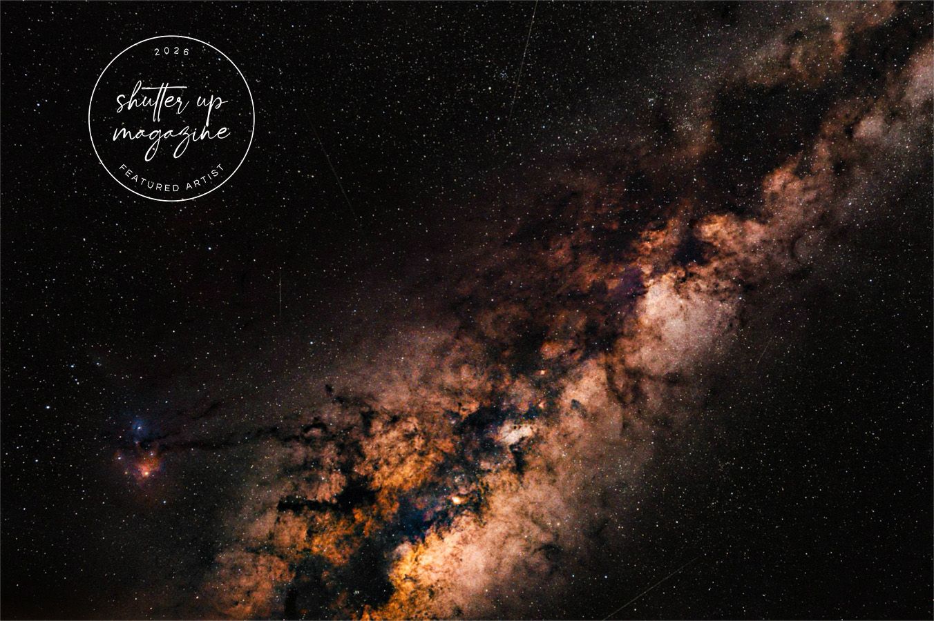 A stunning view of the Milky Way galaxy with orange and dark cosmic clouds stretching across the night sky.