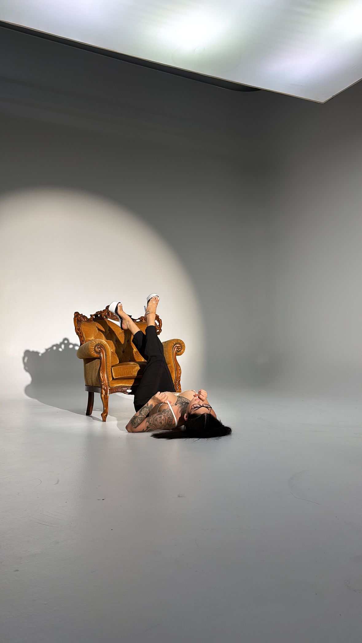 Stop motion sequence showing a wooden toy dinosaur falling over on a gray surface in five progressive frames.