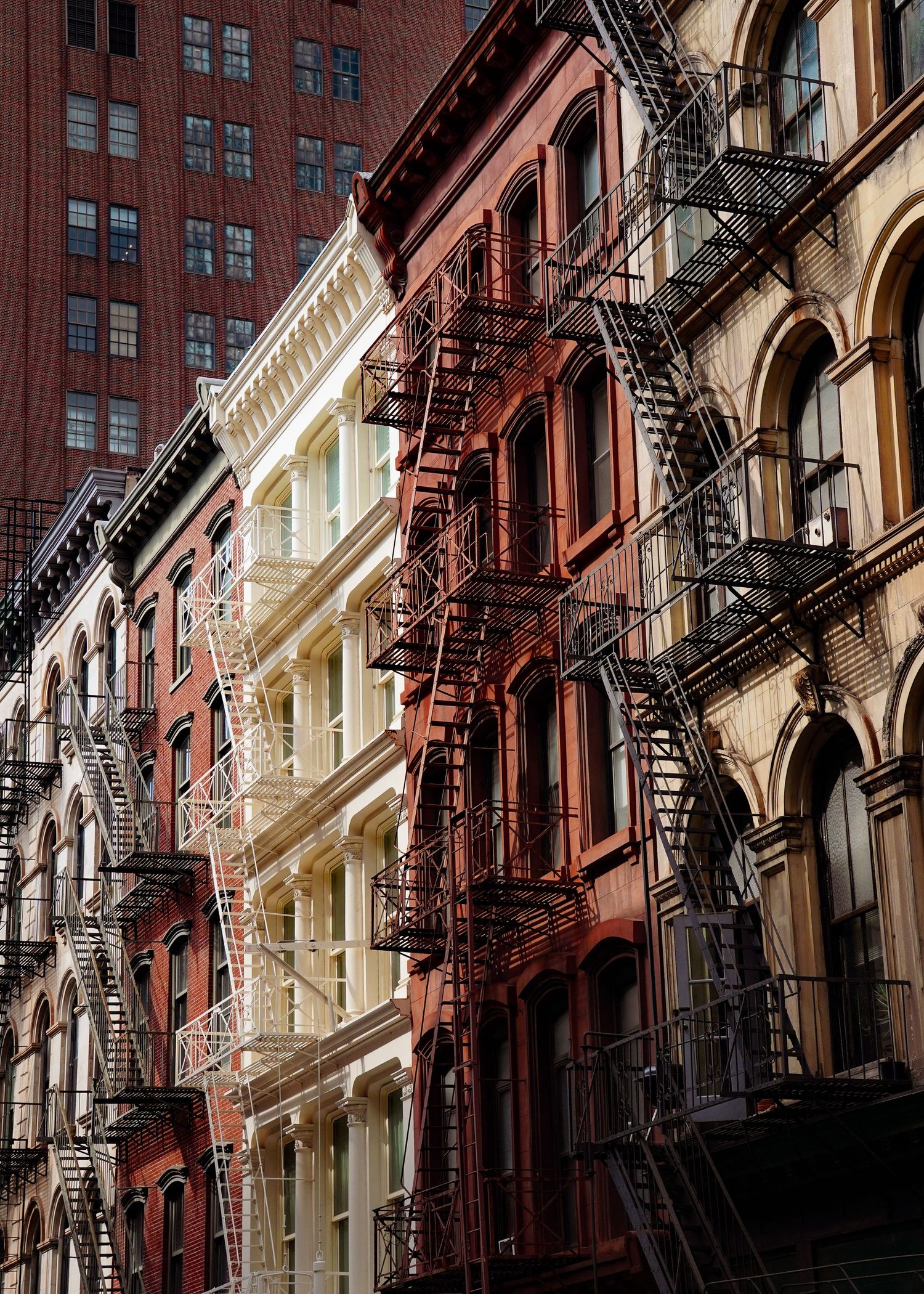 Historic New York City buildings with classic fire escapes and architectural details.