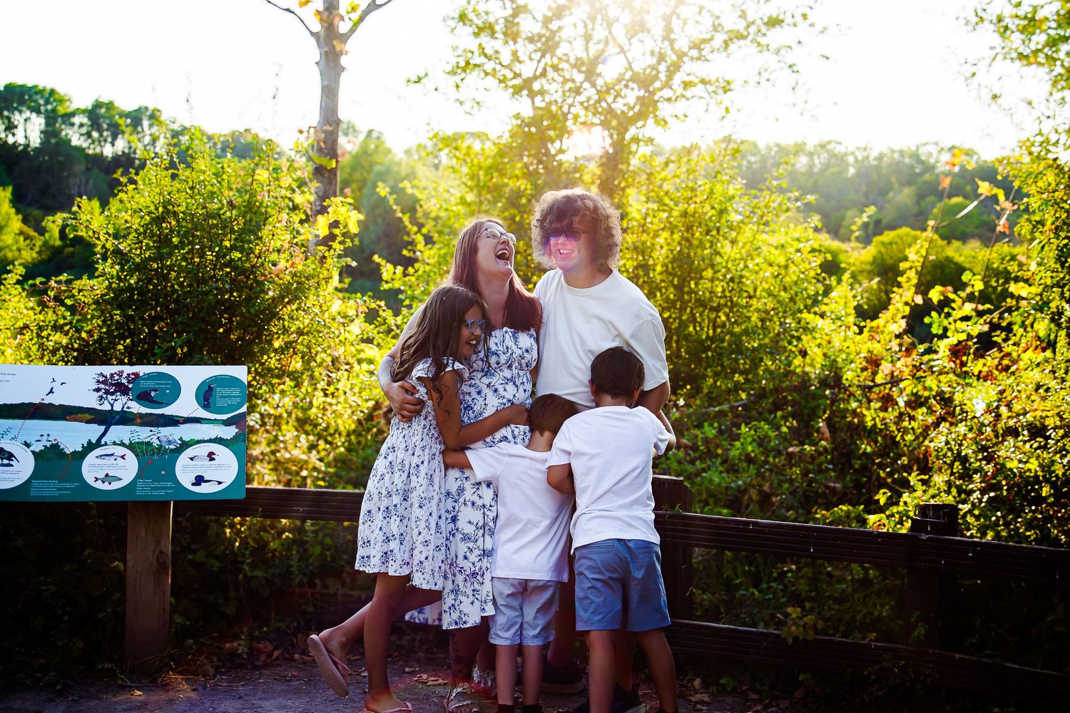 Parents cuddling their children beside the nature trail at Cosmeston Lakes