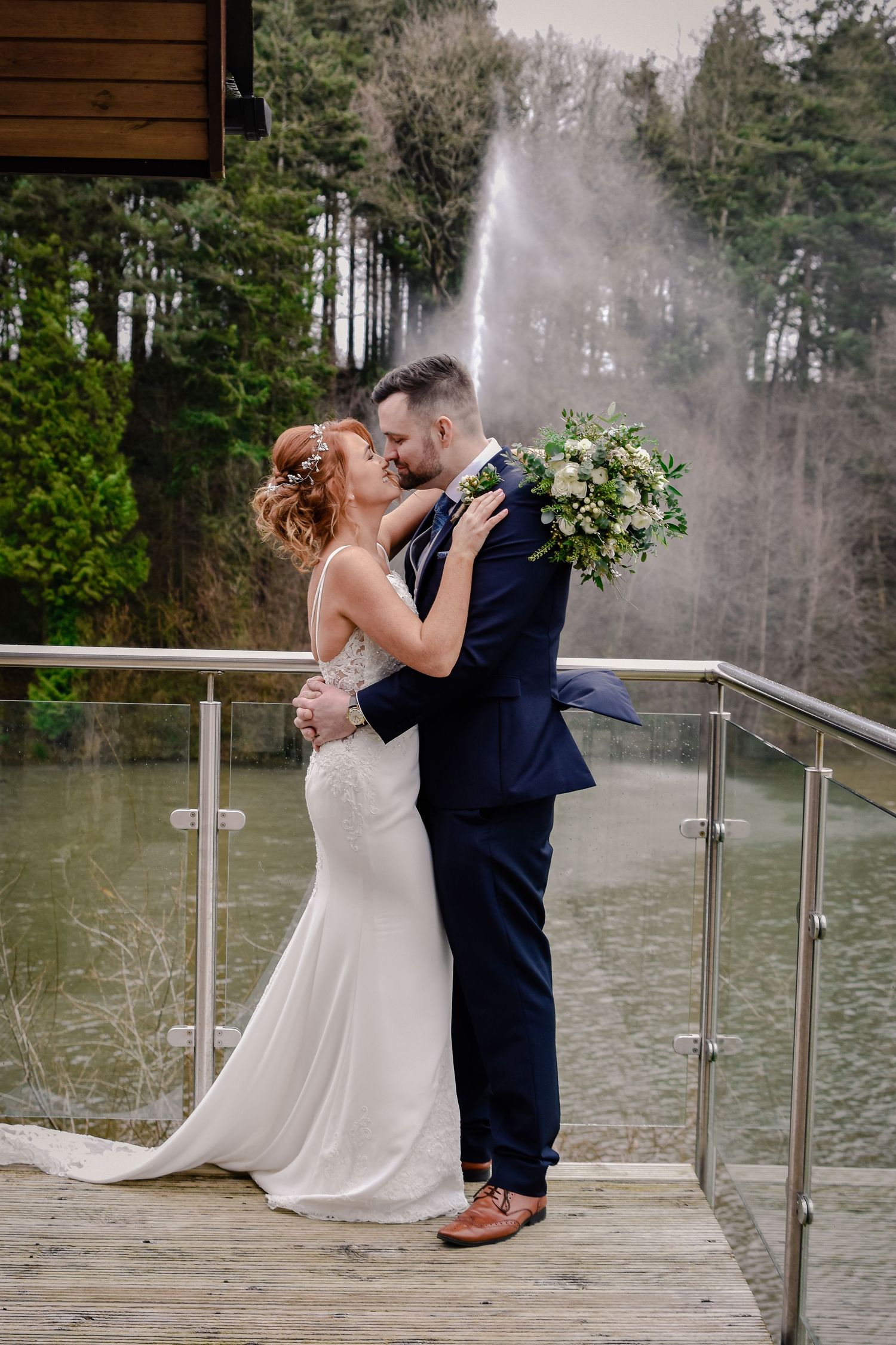 Newlywed couple embracing beside the Canada Lodge waterfall in Cardiff