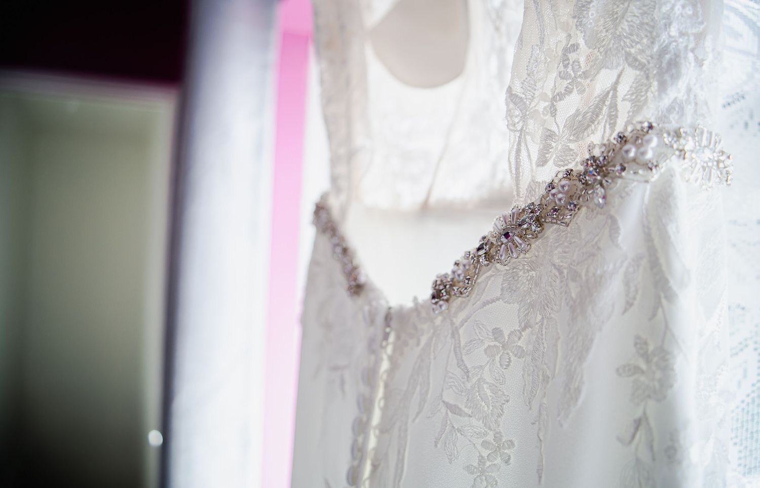 Close-up of the lace and beaded detailing on the wedding dress