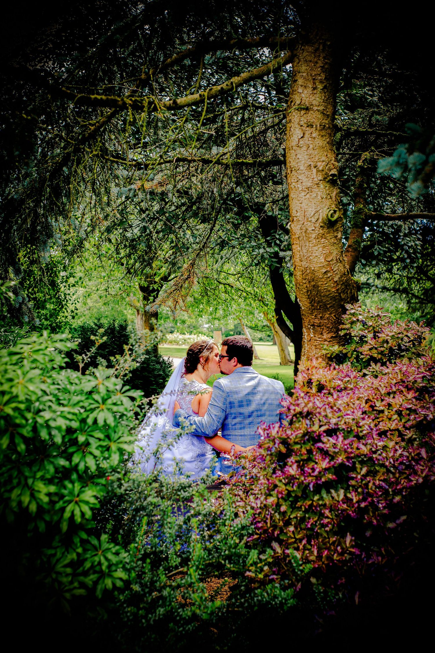Newlyweds sitting together among the colourful gardens