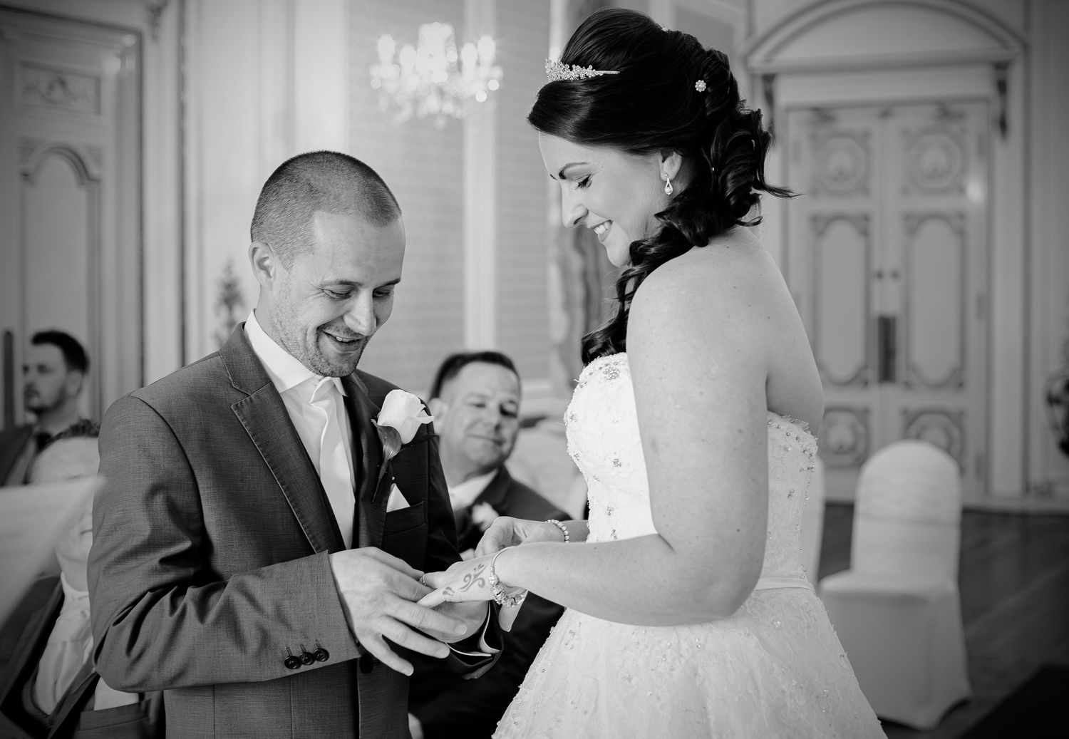 Bride and groom exchanging rings at ceremony, court colmon, bridgend