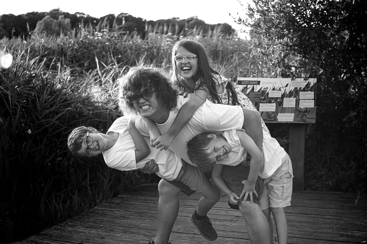 Playful black-and-white family portrait during an outdoor lifestyle session