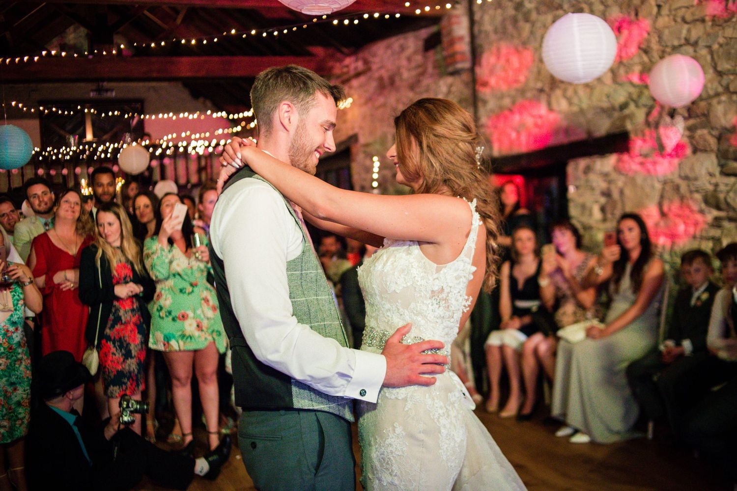 Newly married couple embracing on the dance floor at Pencoed House