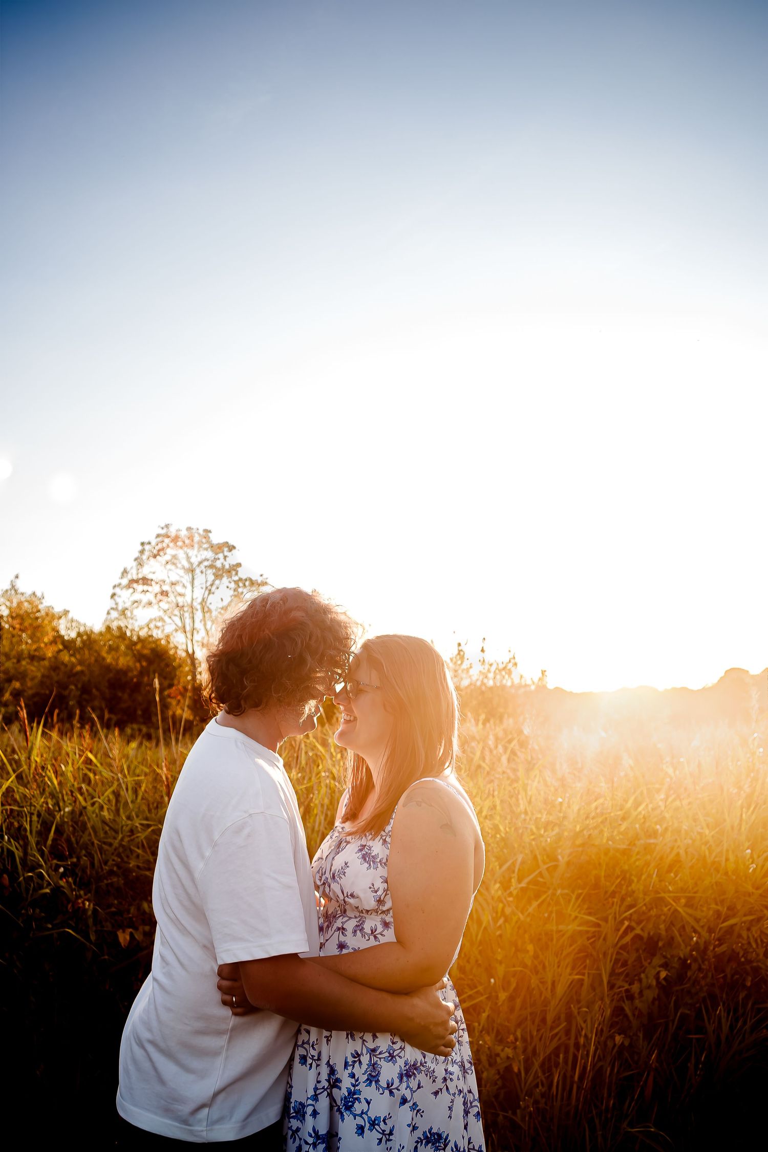 Couple kissing in the golden evening light at Cosmeston Lakes, Penarth