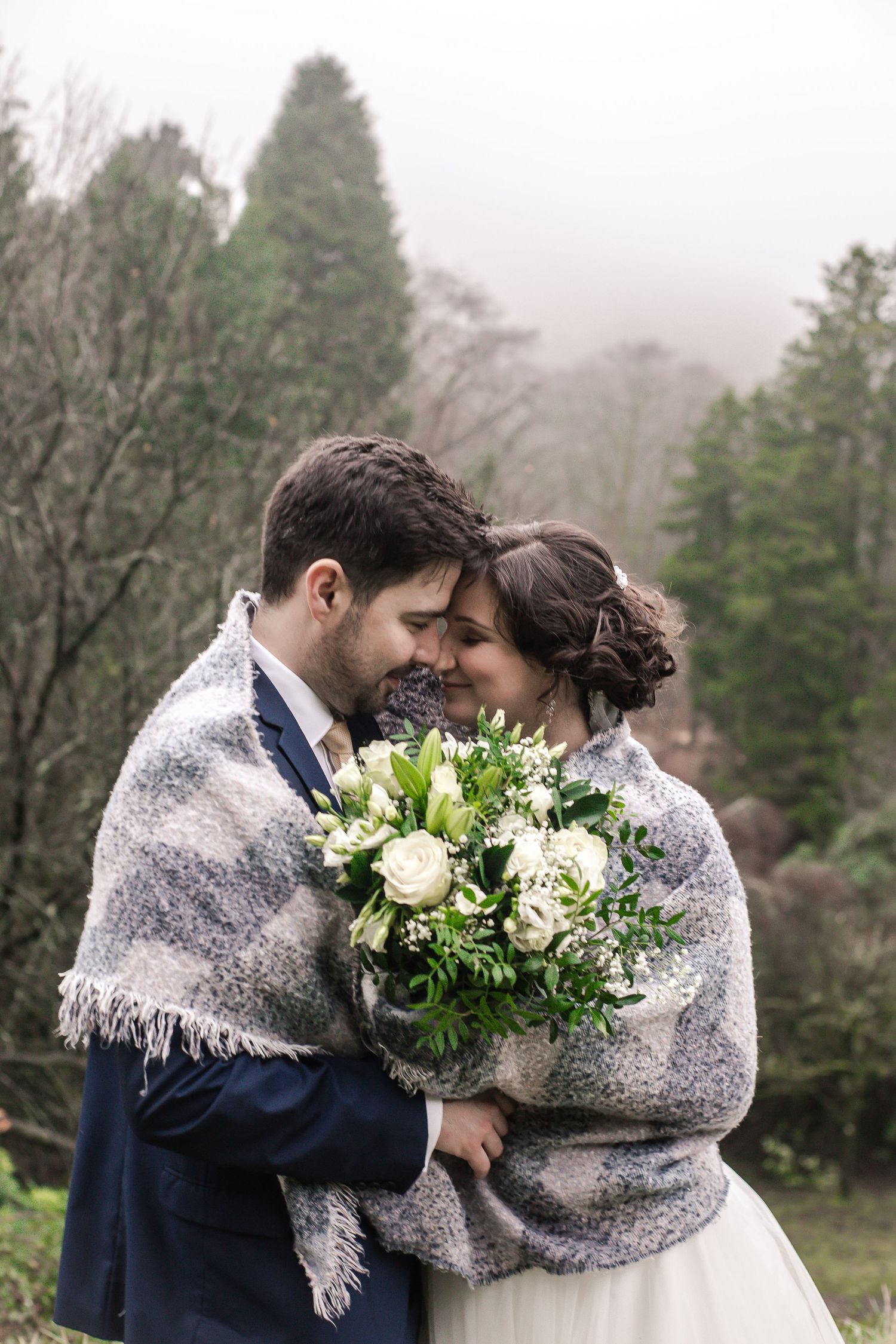 Bride and groom sharing a quiet kiss in the Craig y Nos Castle gardens
