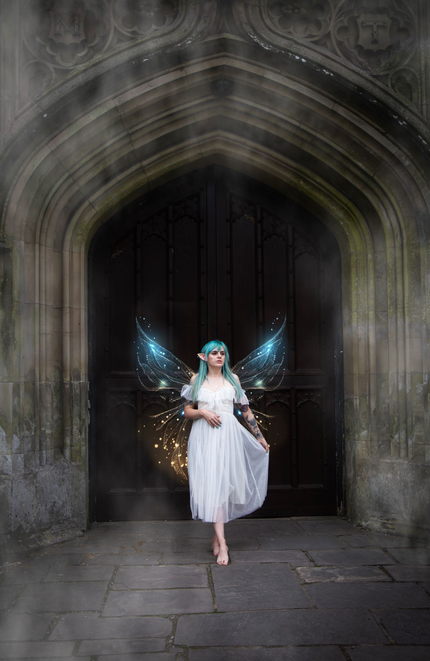 Child dressed as a fairy standing inside a dramatic stone archway