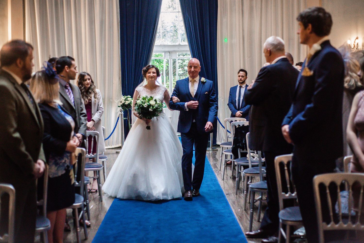 Bride walking down the aisle during a Craig y Nos Castle wedding