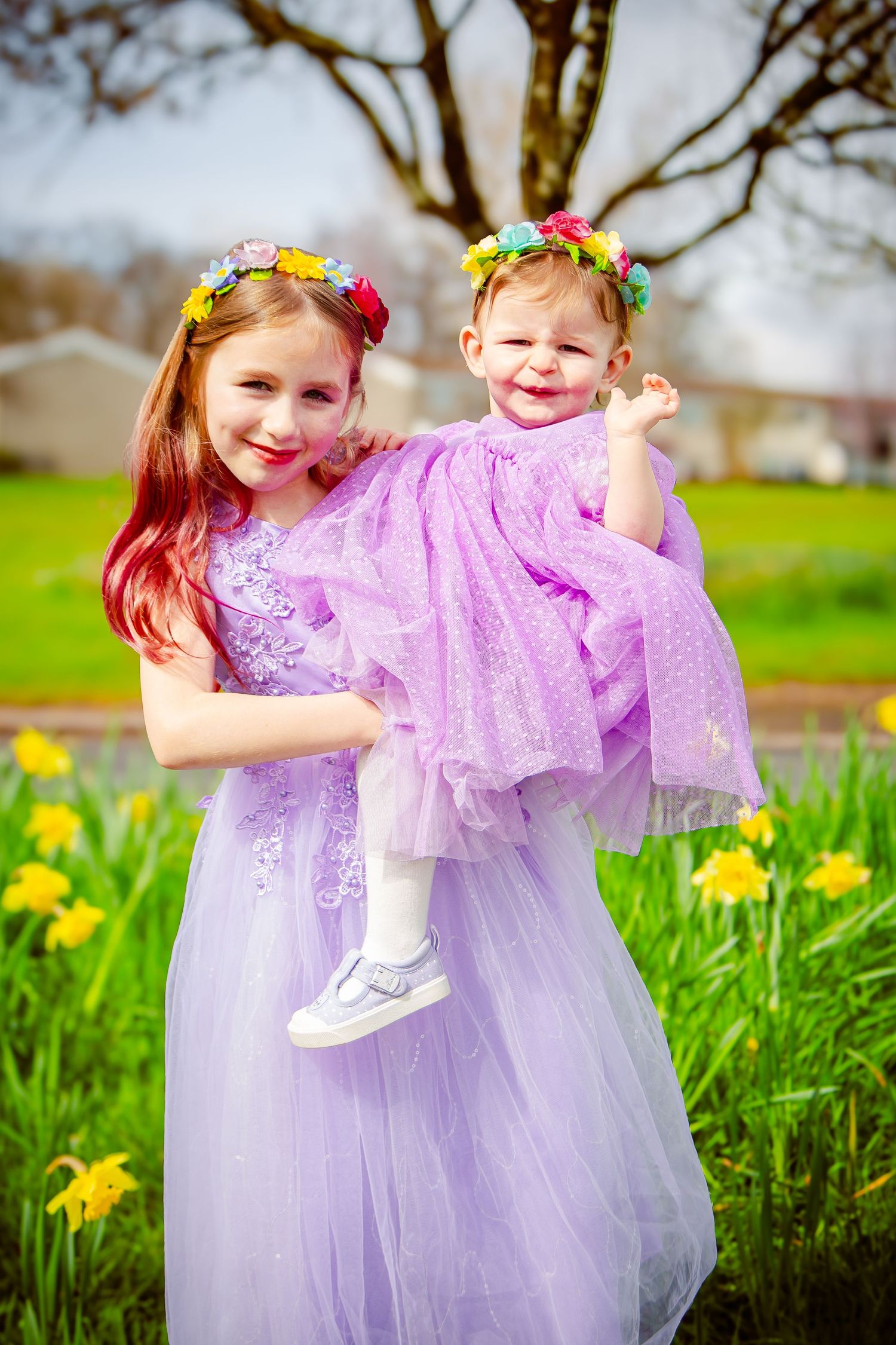Sisters smiling together during a colourful spring photoshoot