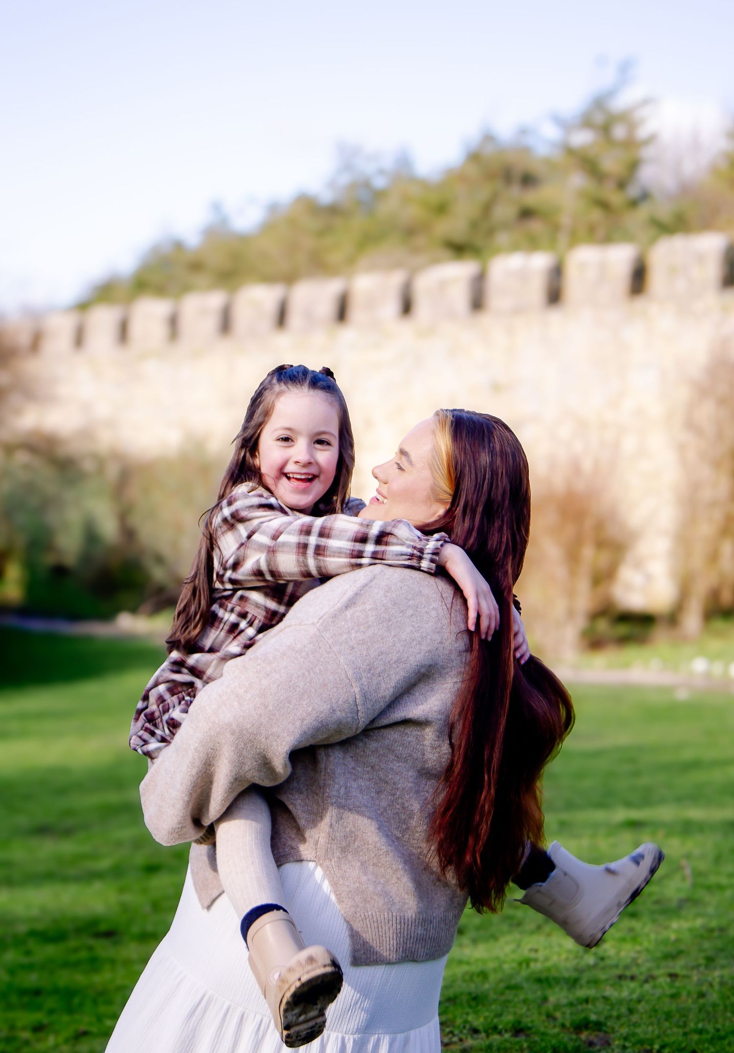 Mother playfully carrying her daughter during a Southerndown family session