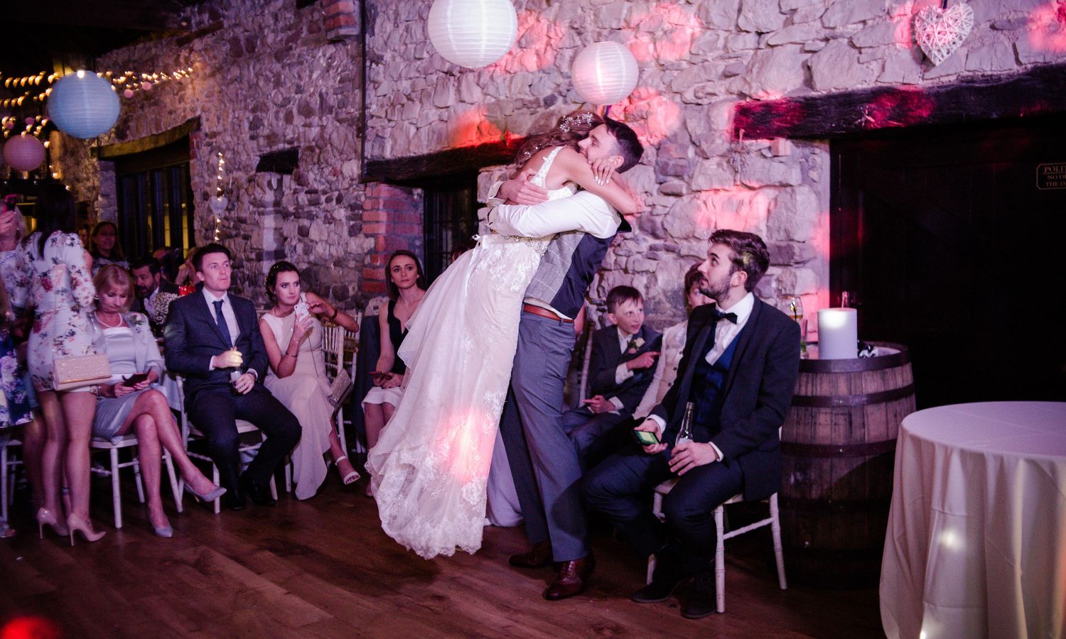Groom lifting his bride during their lively first dance at Pencoed House