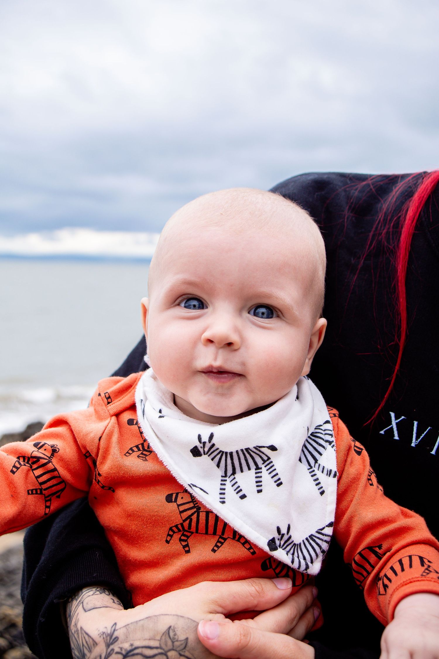 Baby looking towards the camera during a seaside family photoshoot