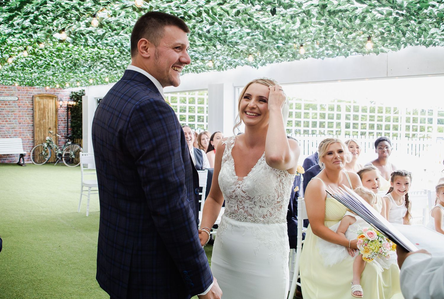 Bride and groom laughing together during their wedding ceremony