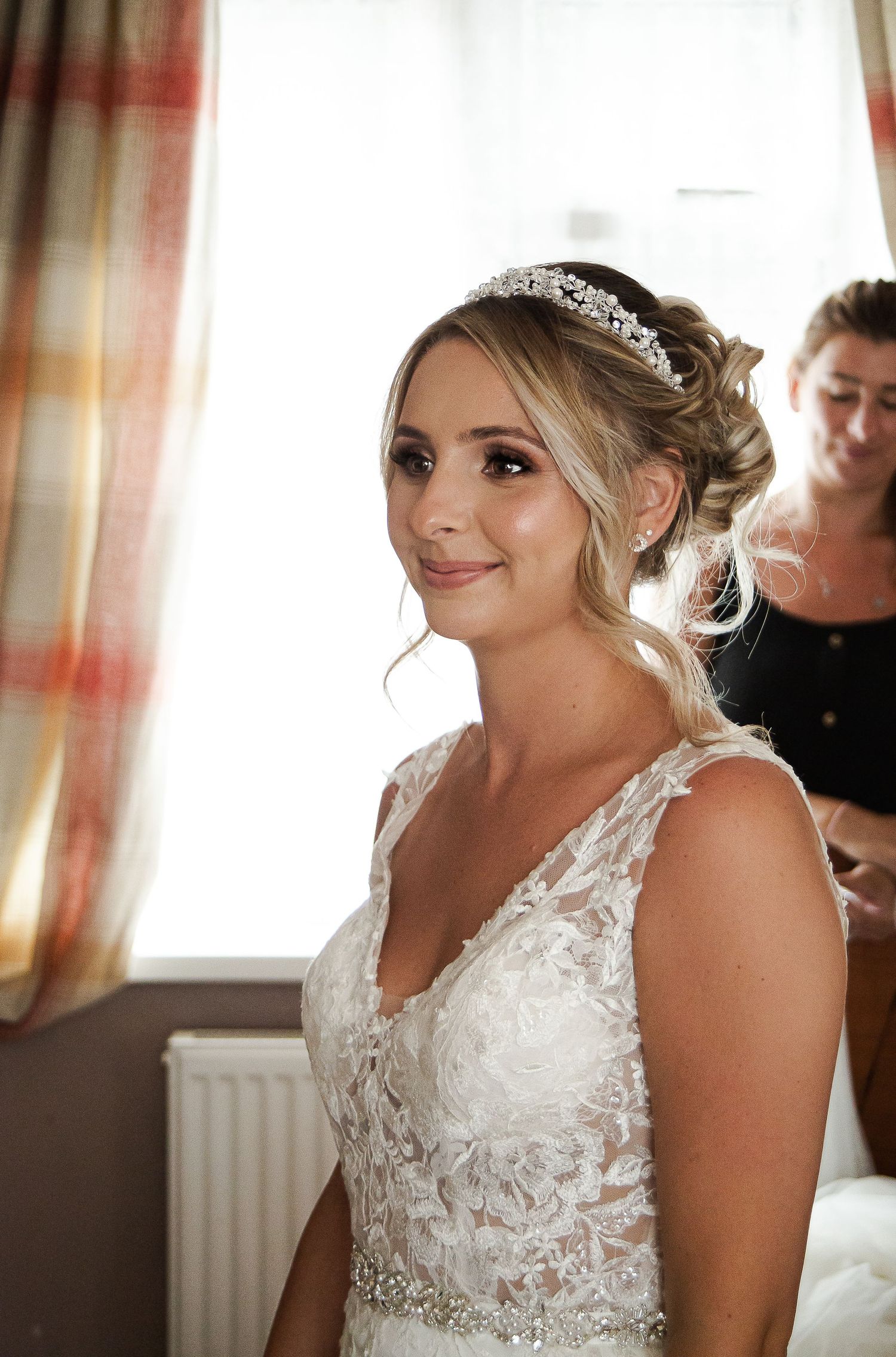 Bride smiling during the final moments of her wedding preparations