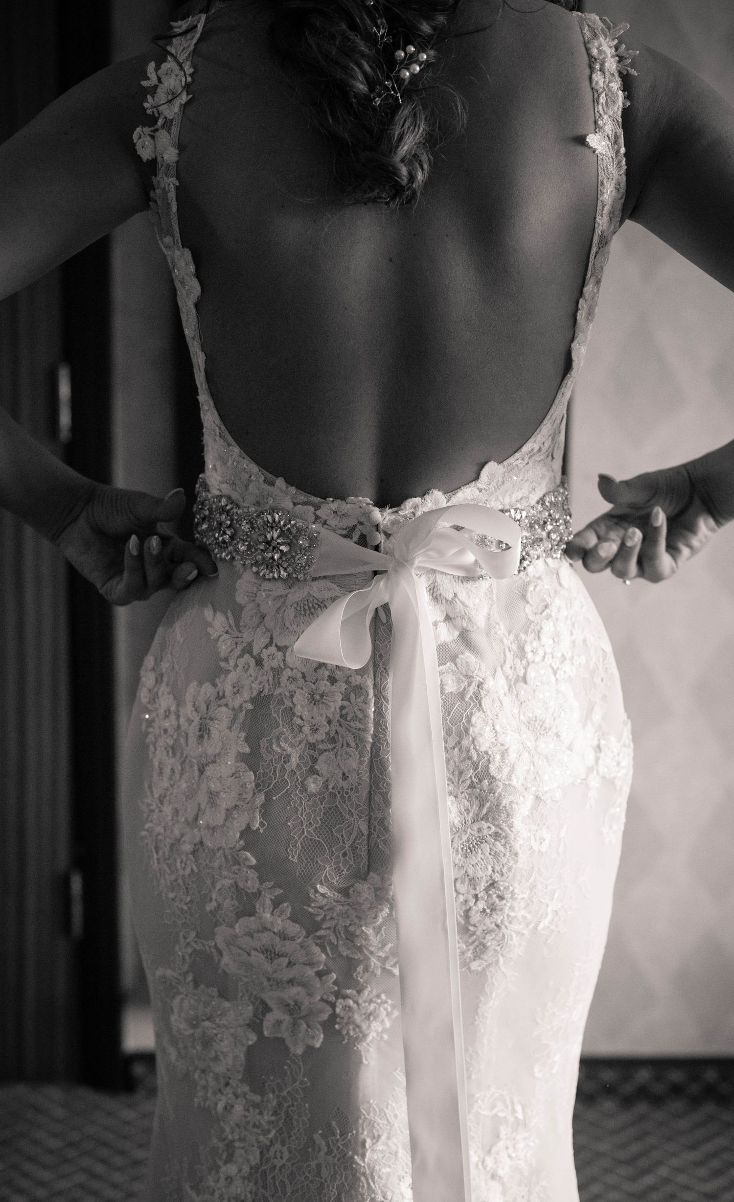 Bride wearing a detailed lace wedding dress during morning preparations