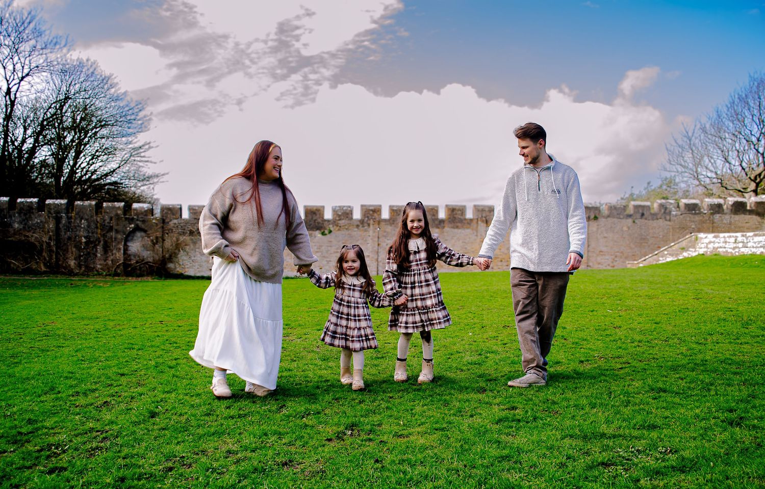 Family of four walking hand in hand during a Southerndown photoshoot