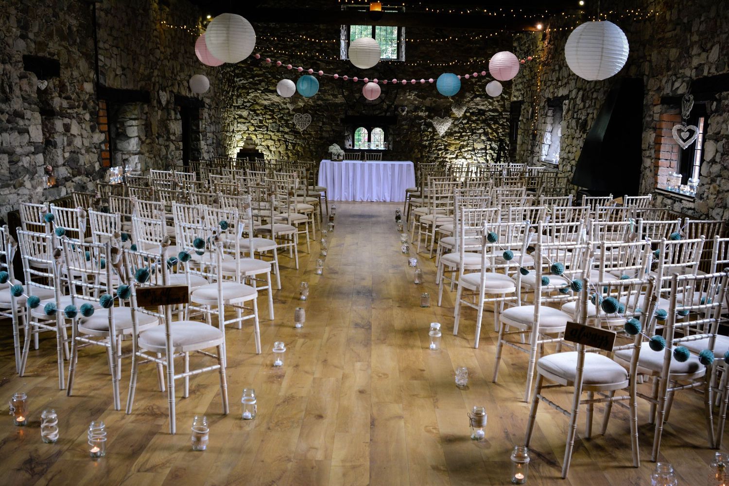 Rustic stone reception room prepared for a wedding at Pencoed House