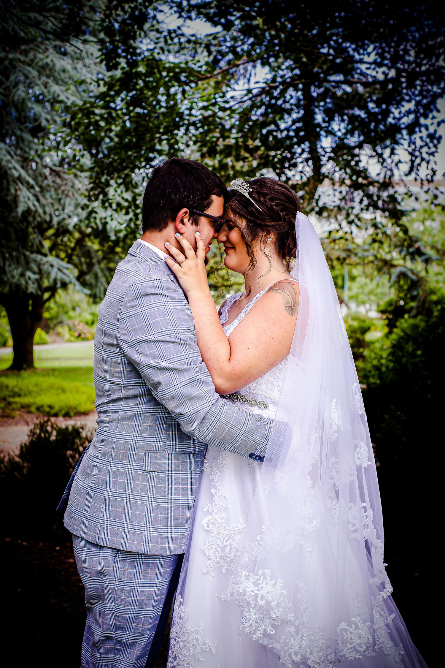 Bride and groom embracing during their Sophia Gardens wedding portraits