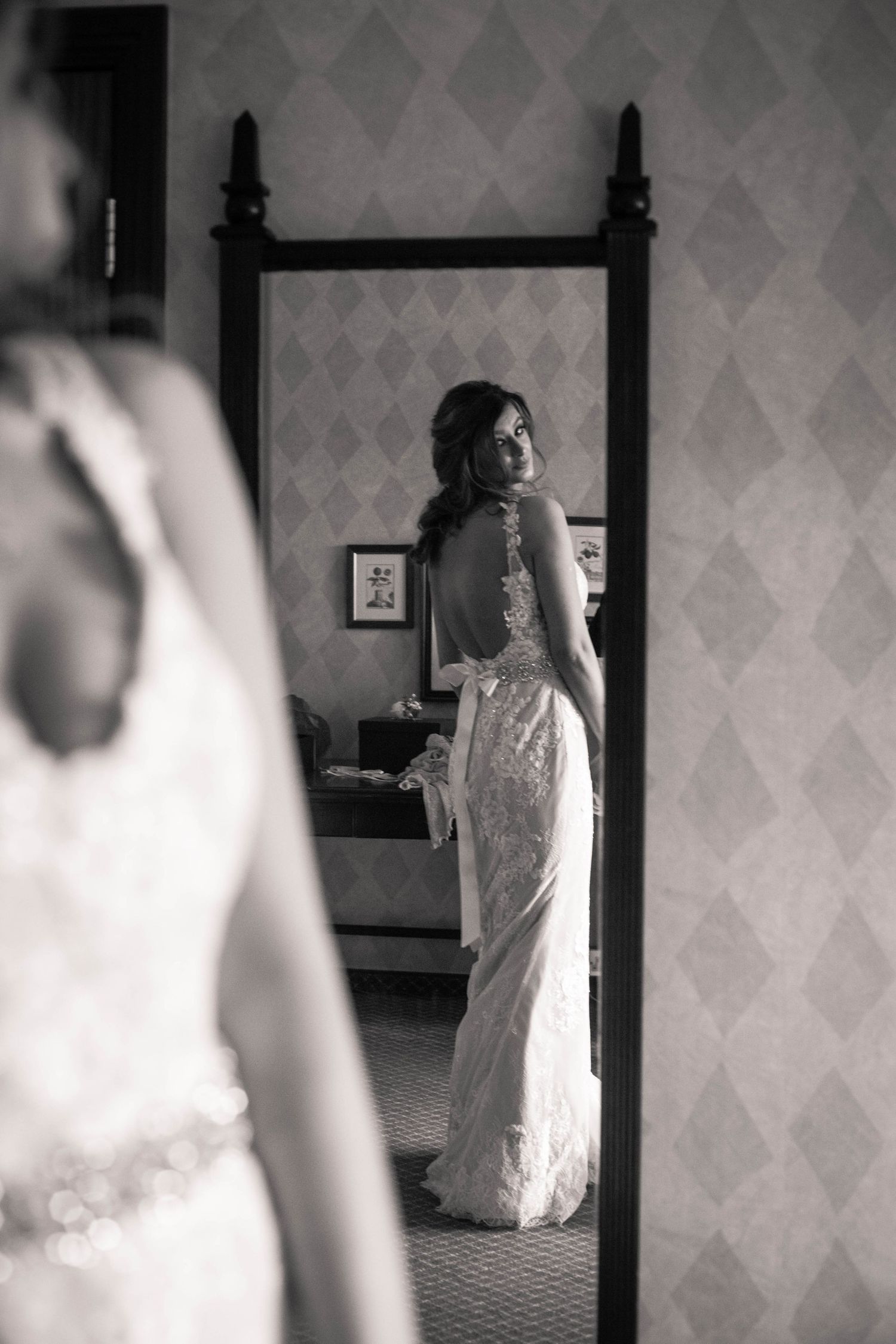 Black and white bridal portrait reflected in a bedroom mirror