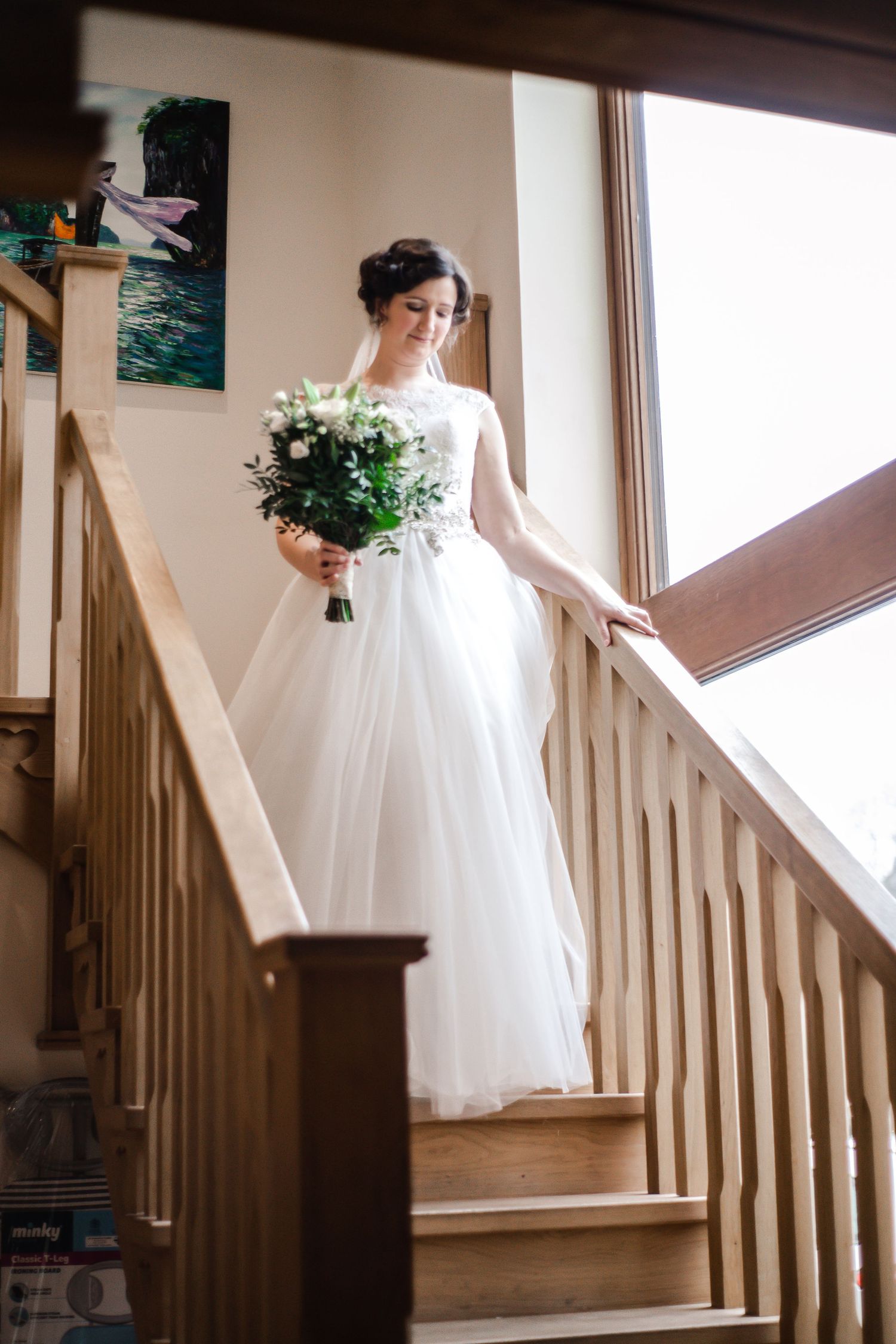 Bride standing on the staircase during preparations at Craig y Nos Castle