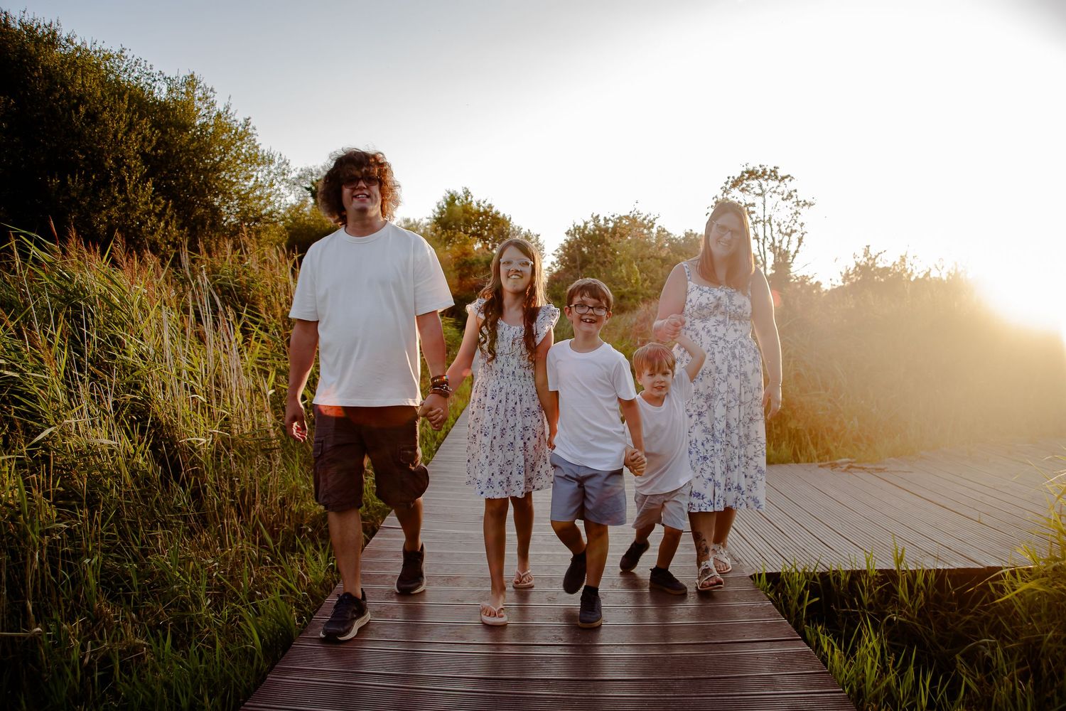 Family walking towards the camera at sunset in Cosmeston Lakes