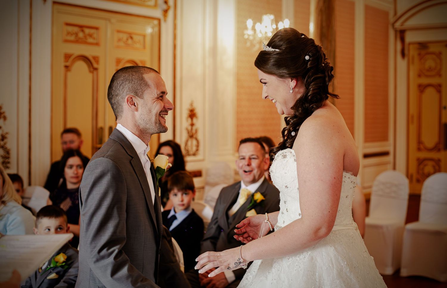 Bride and groom laughing with each other at ceremony, court colmon, bridgend