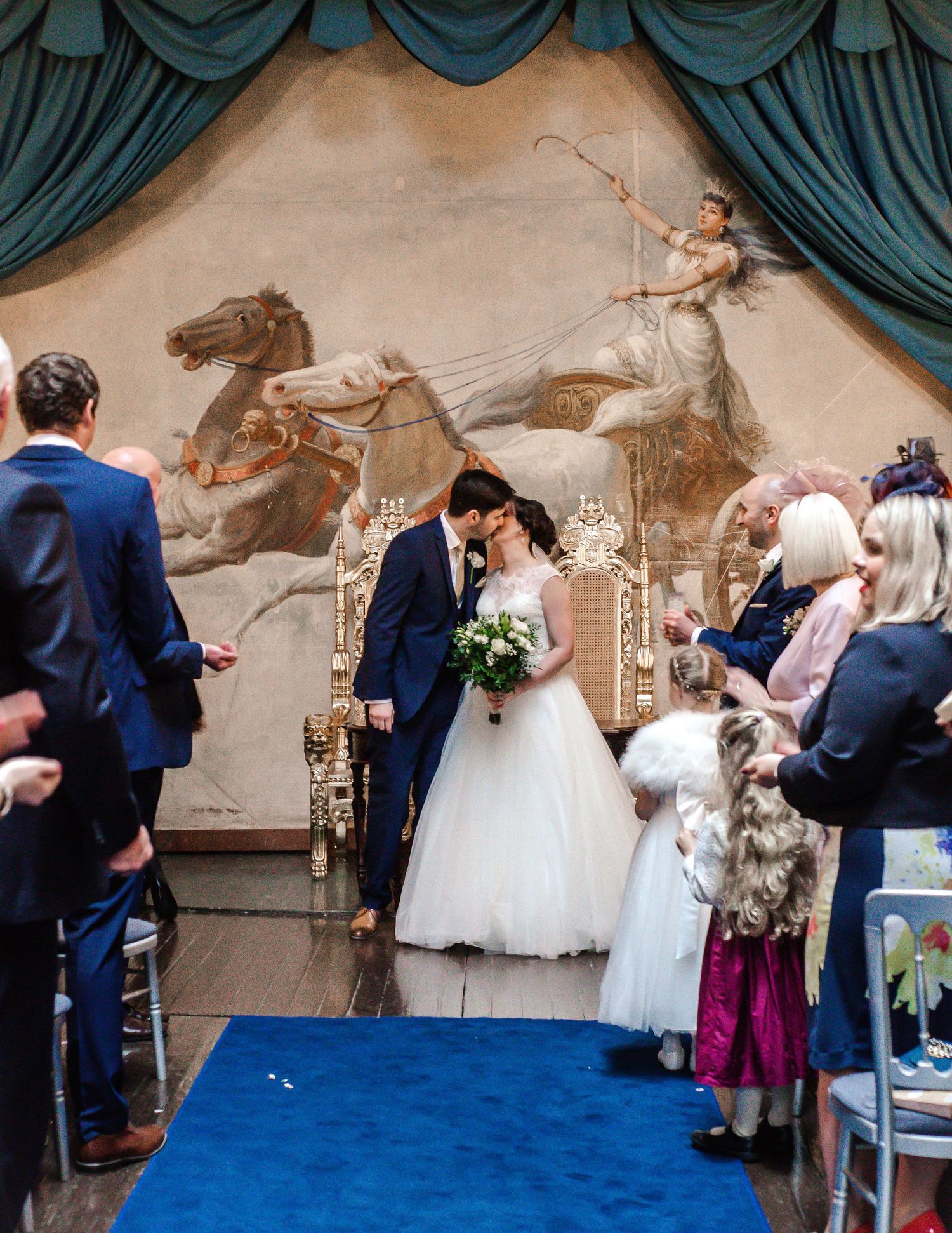 Newlyweds celebrating with guests after their wedding ceremony inside Craig y Nos Castle
