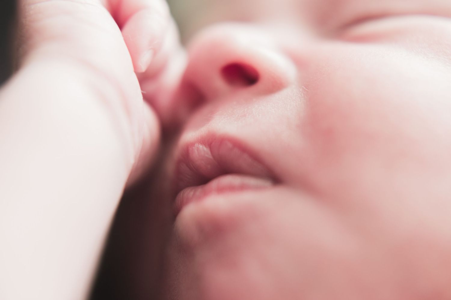 Close-up of a newborn baby’s face and delicate lips