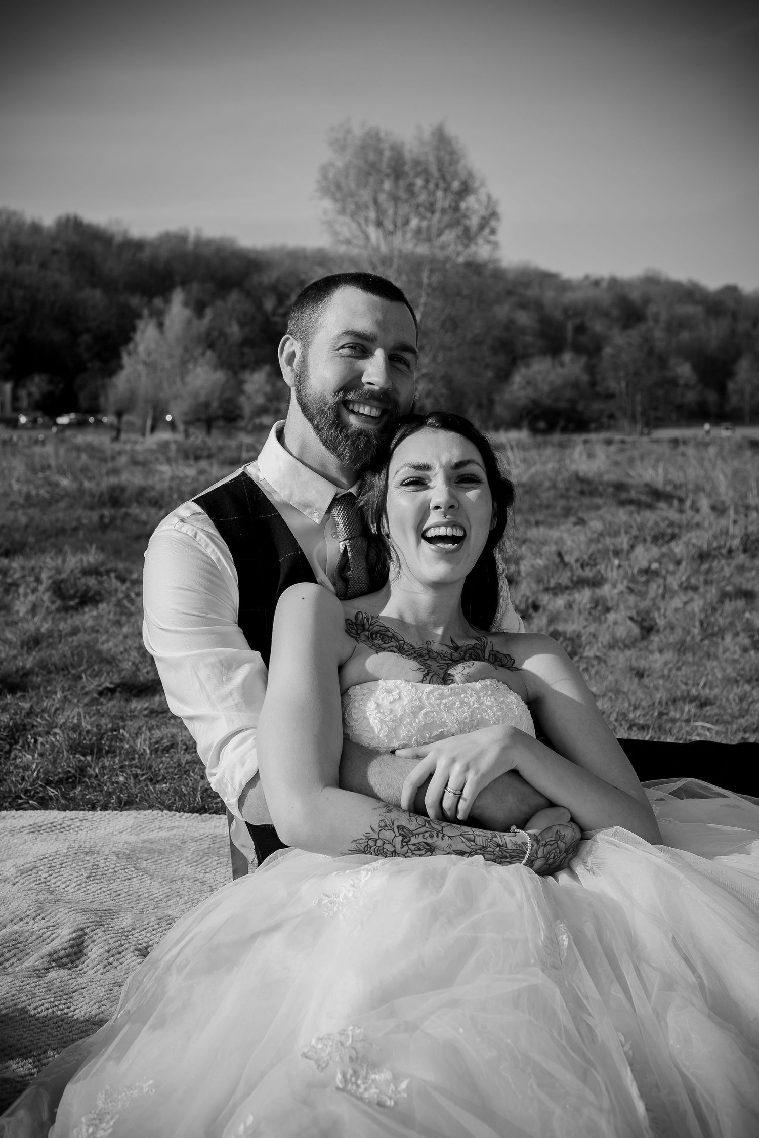Black-and-white portrait of the couple sitting together outdoors
