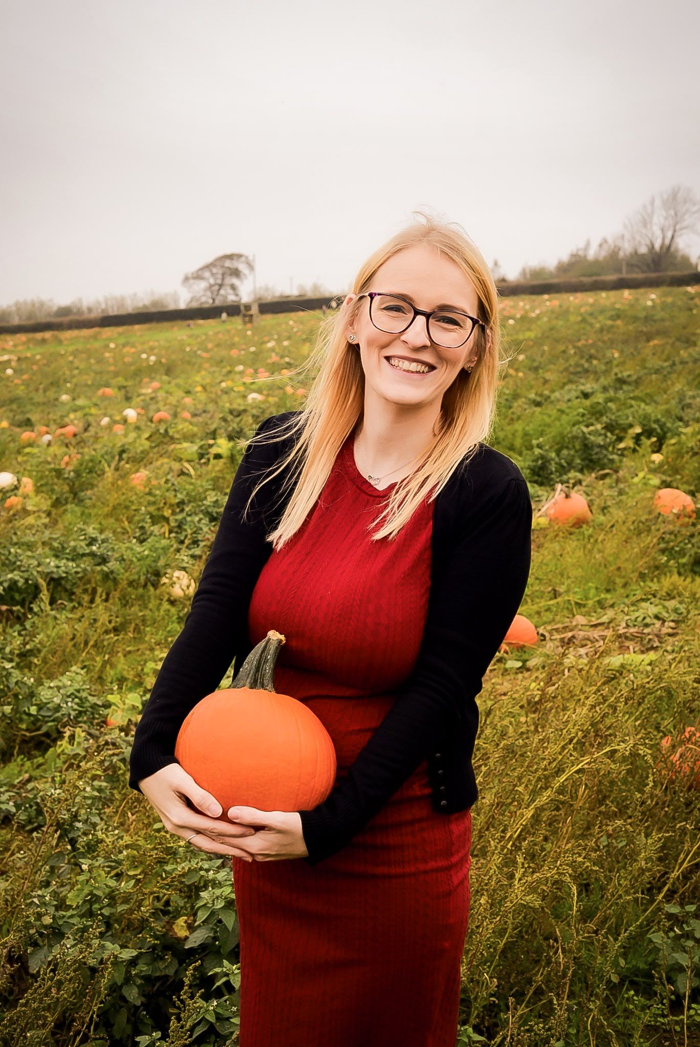 Smiling model holding a pumpkin at PYO pick your own pumpkins, cowbridge