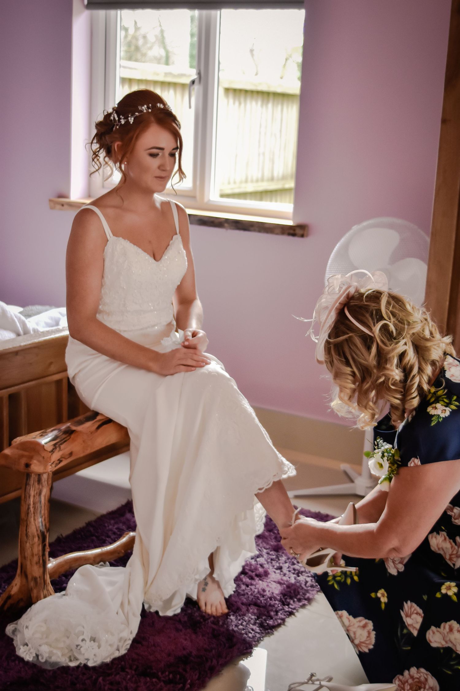 Bride seated while mother of bride helps prepare for her Canada Lodge wedding