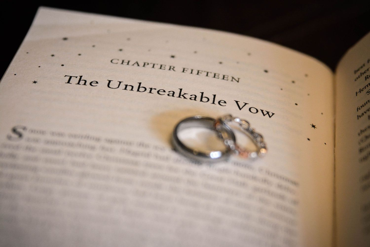 Wedding rings placed on the Unbreakable Vow chapter of a Harry Potter book