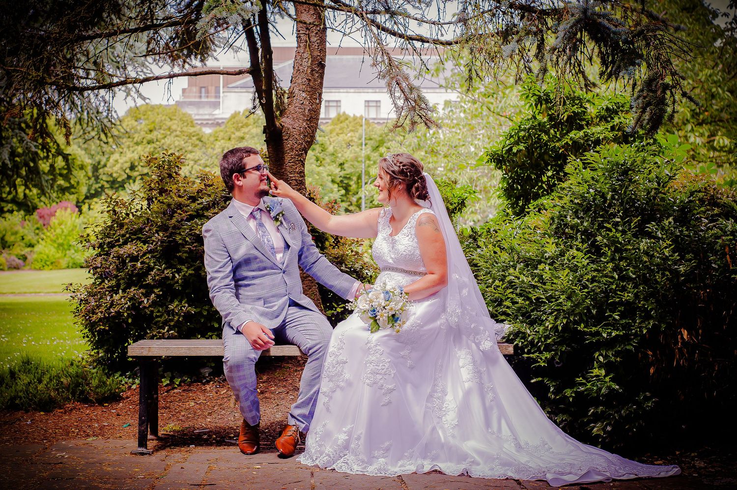 Bride laughing with the groom during playful wedding portraits