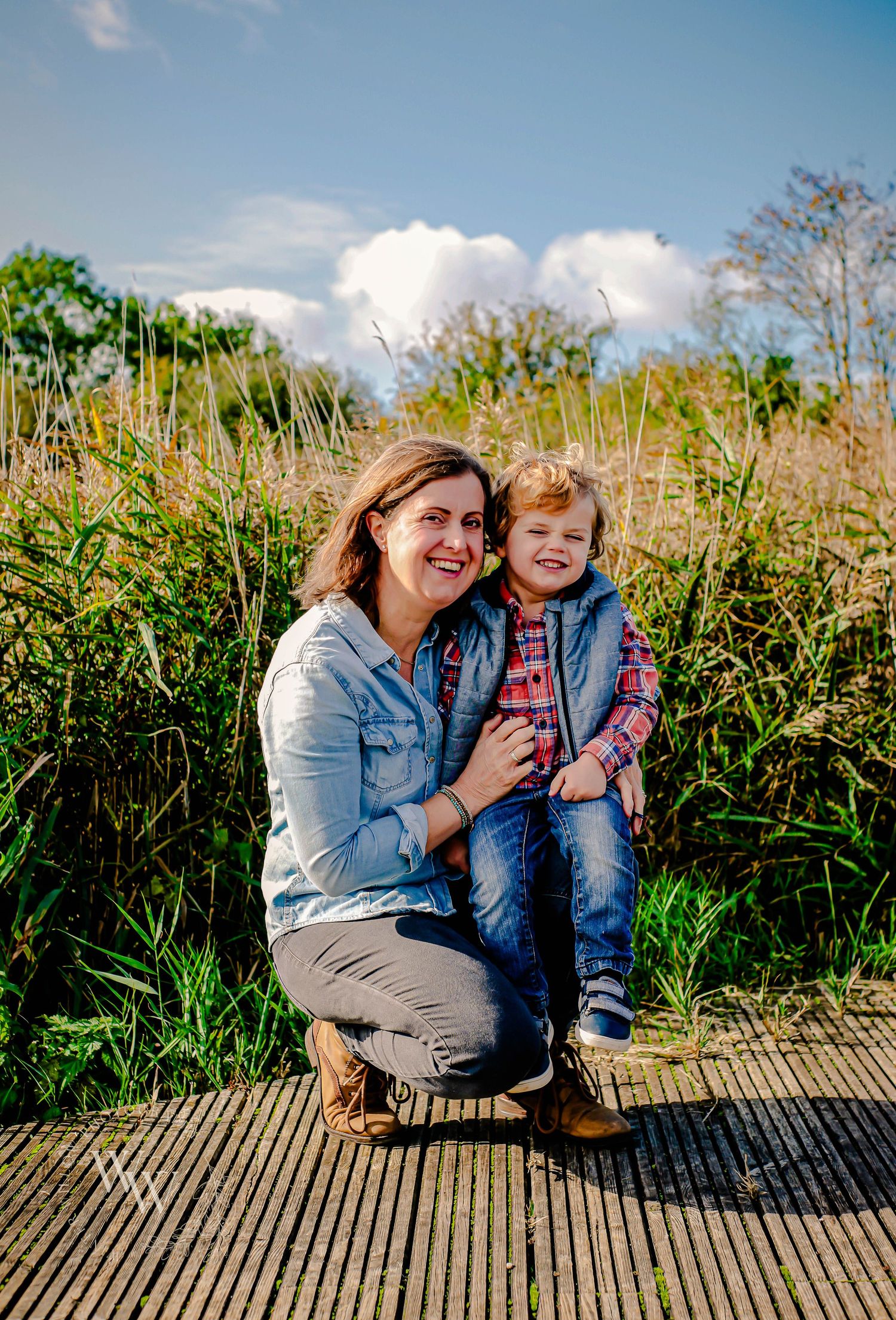 Mother cuddling her child beside the reeds at Cosmeston Lakes