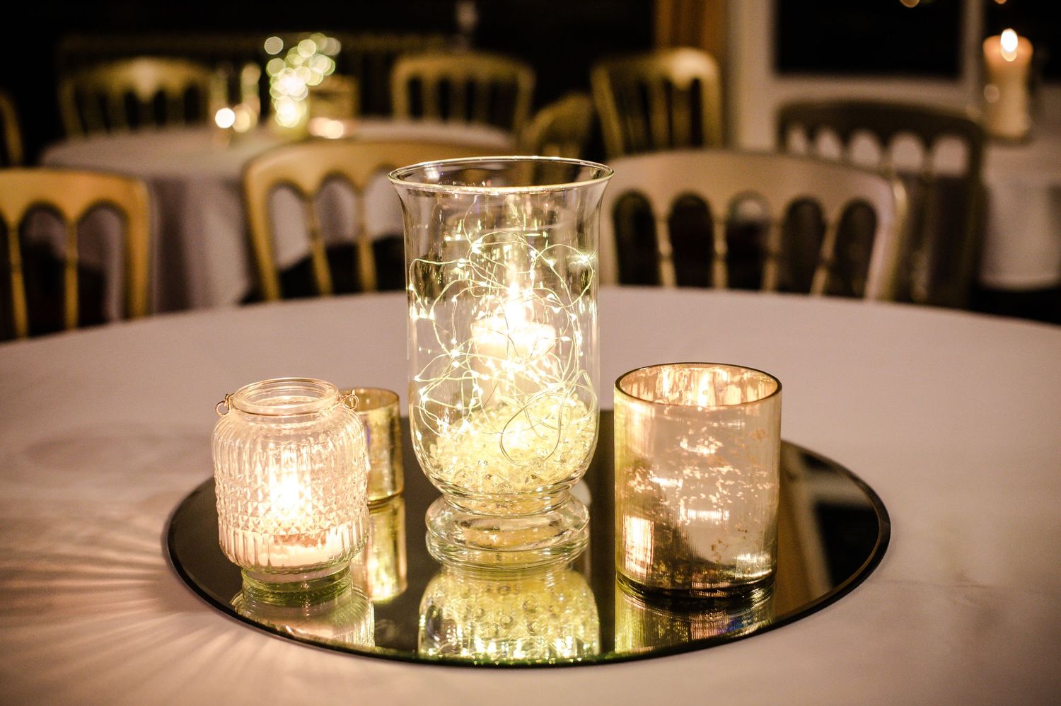 Wedding reception tables arranged inside Craig y Nos Castle conservatory