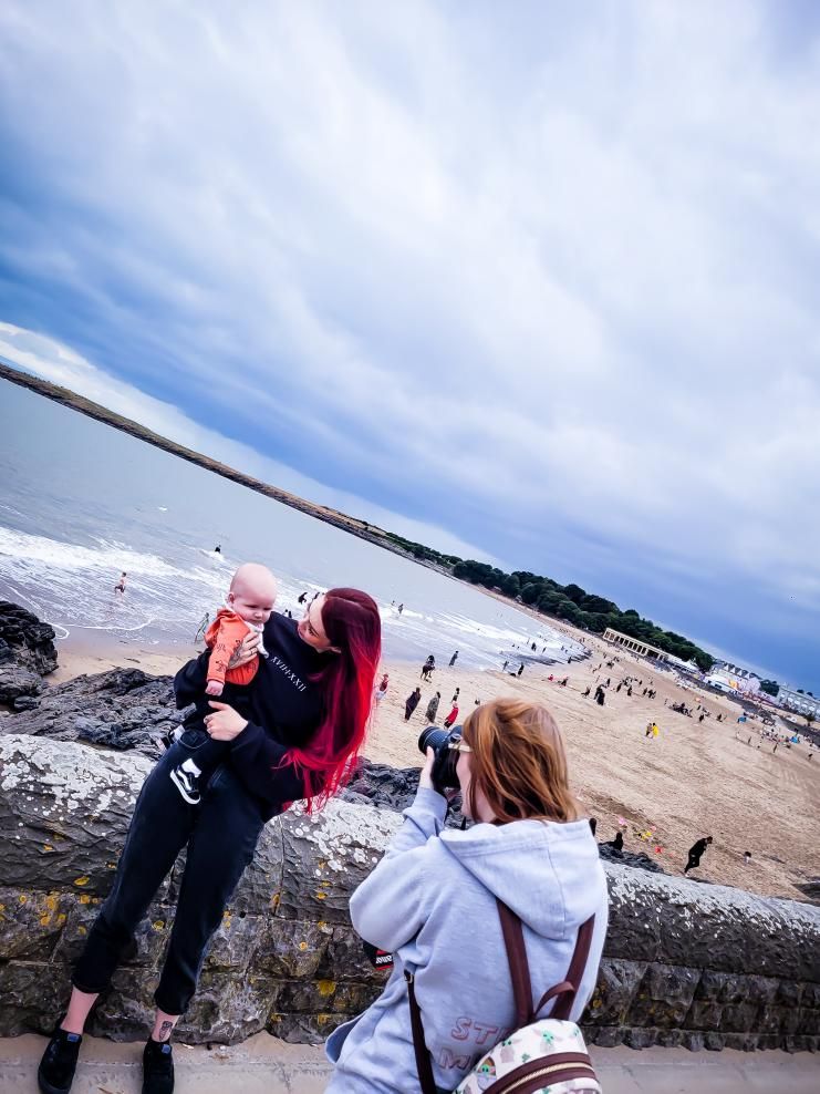 Photographer taking a photograph of family at Barry Island