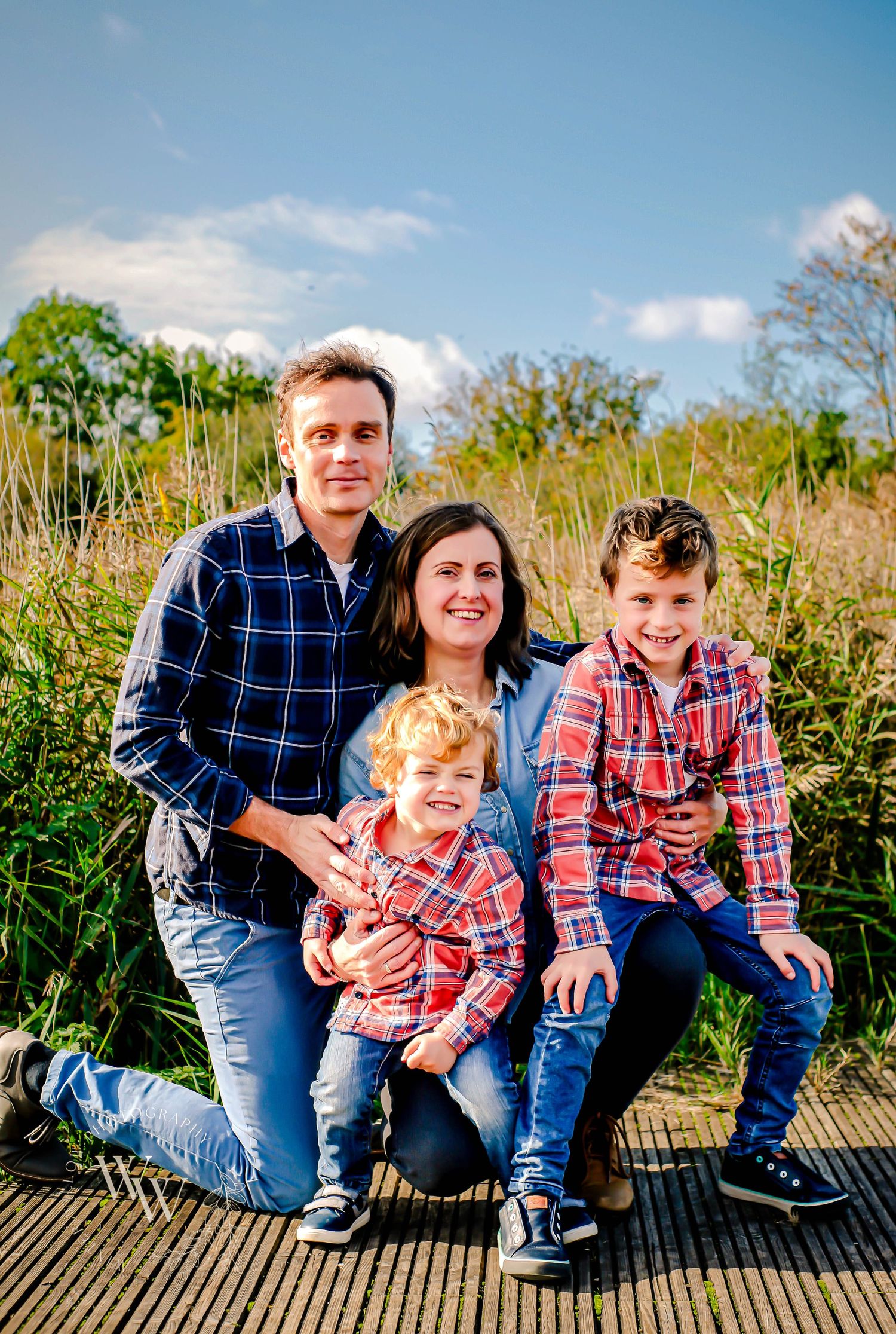 Family of four posing together during a Cosmeston Lakes photoshoot