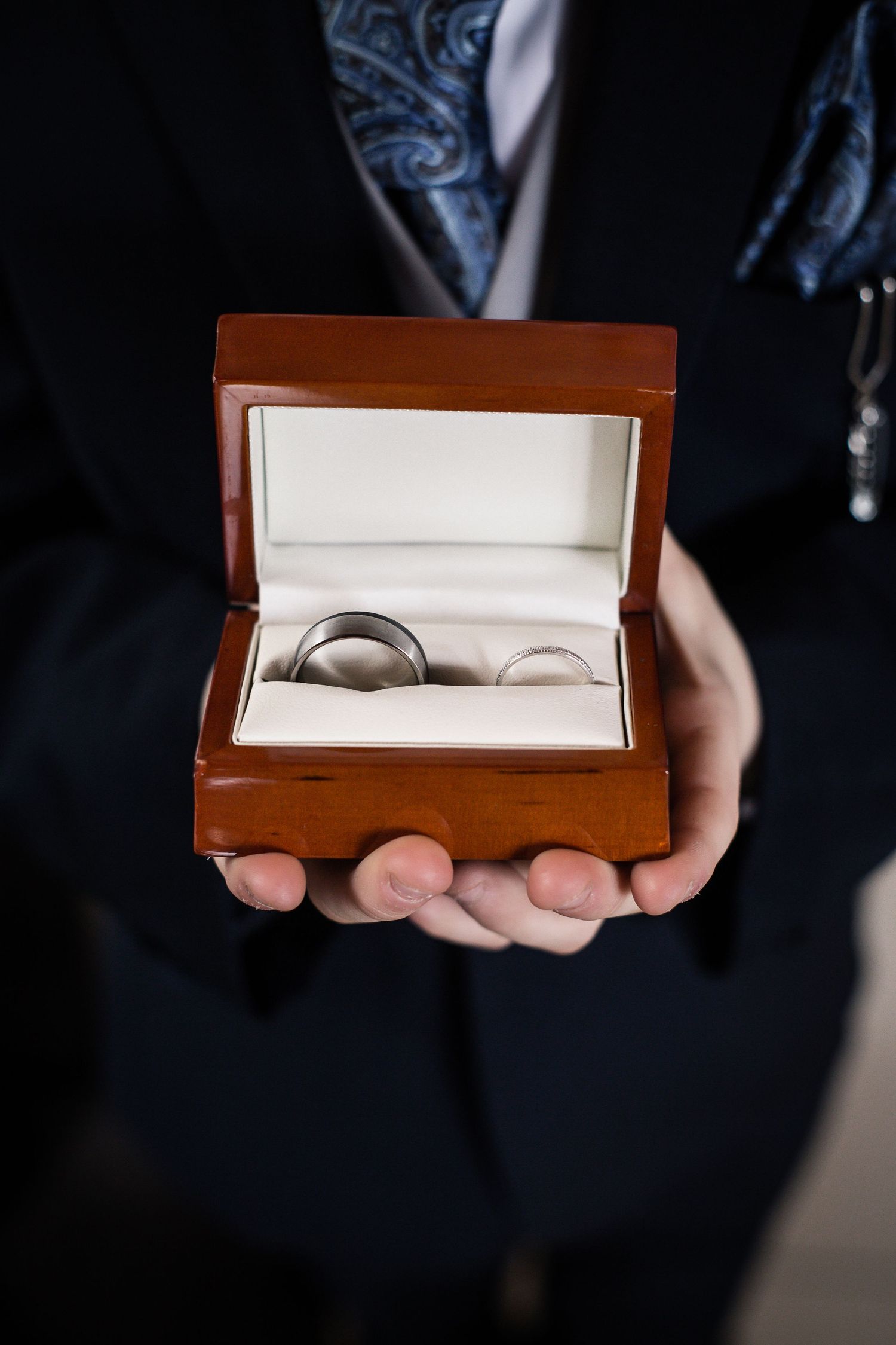 Page boy holding an open wedding ring box before a Canada Lodge ceremony