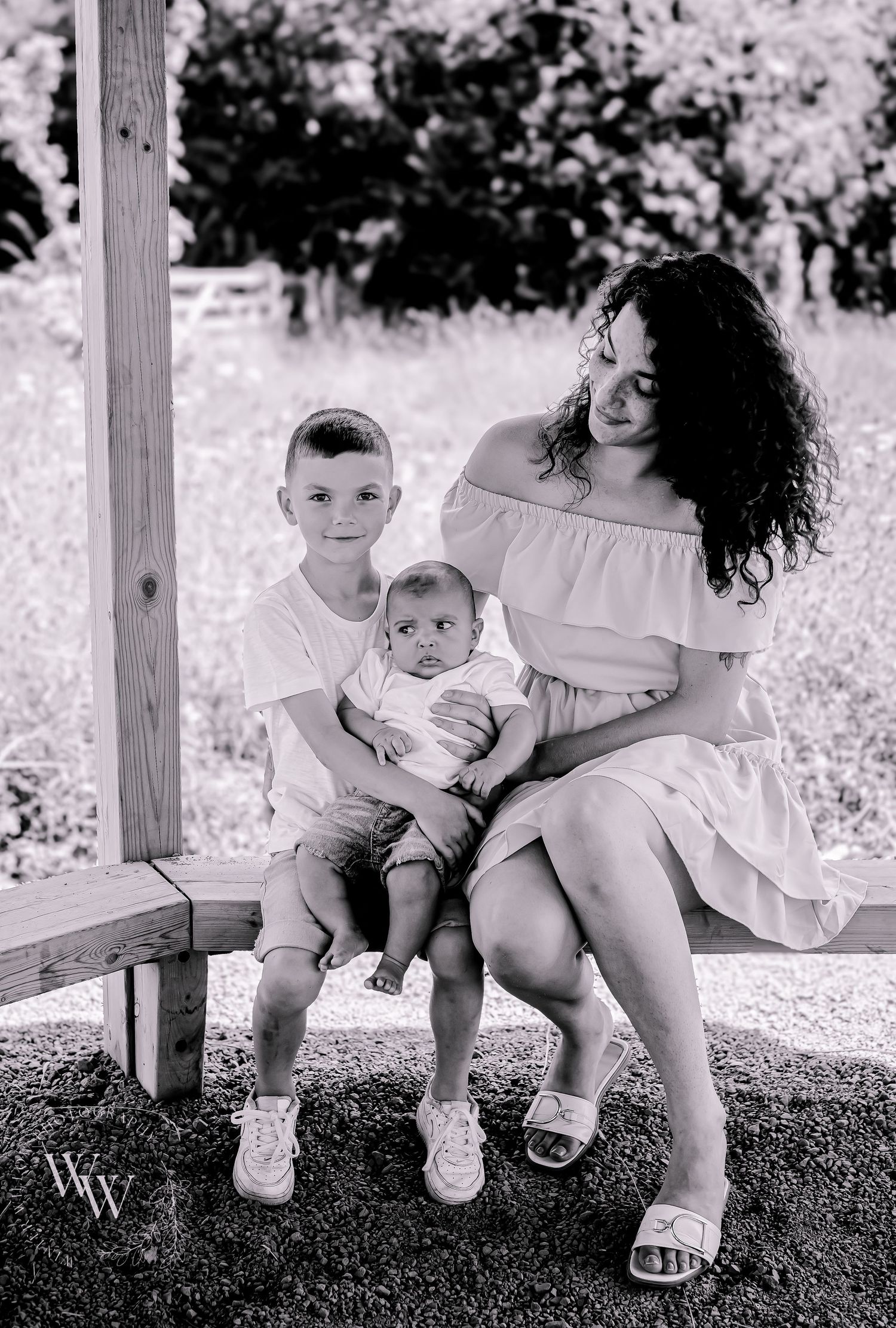 Black and white family portrait of a mother with her young sons at Cosmeston Lake, Penarth
