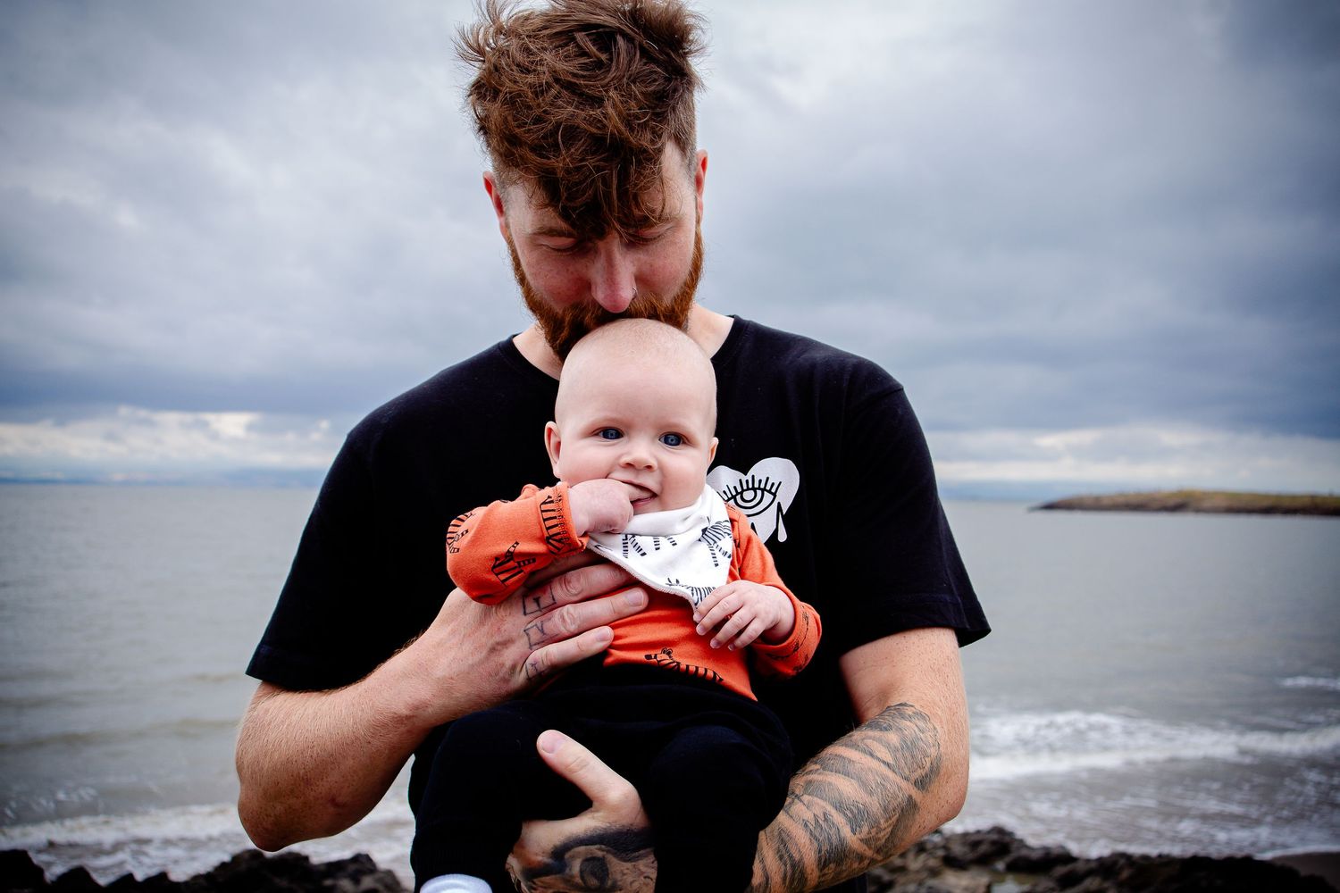 Father and baby photographed beside the sea at Barry Island