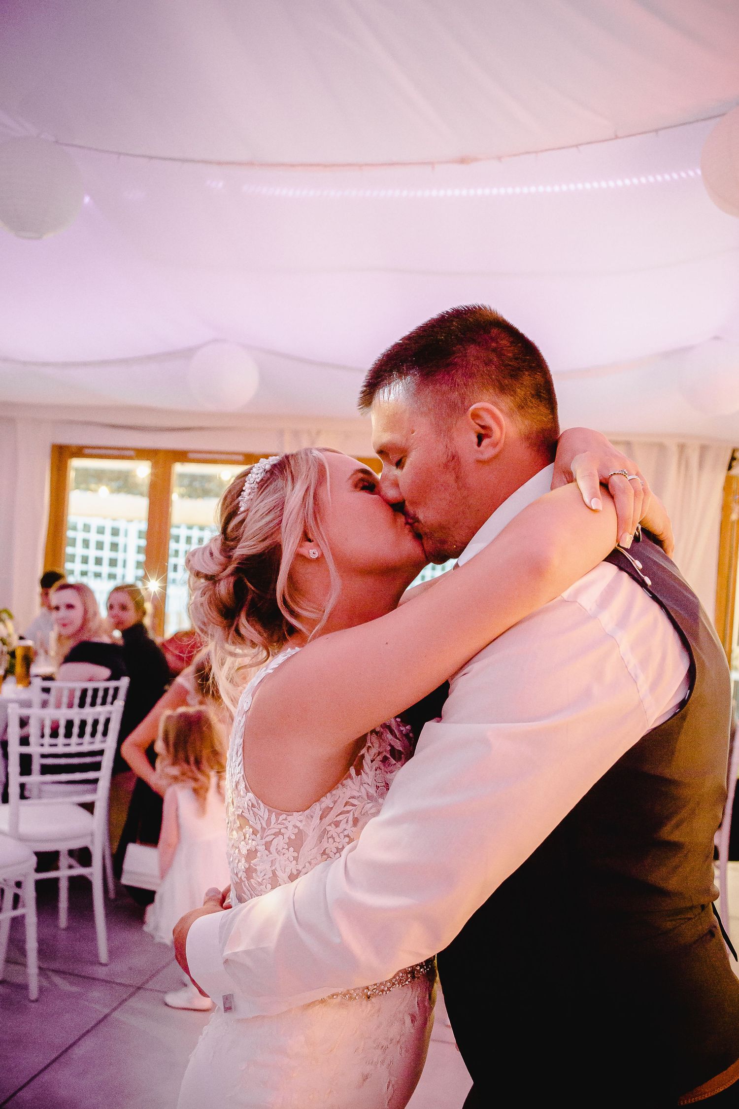 Newlyweds kissing during their romantic first dance