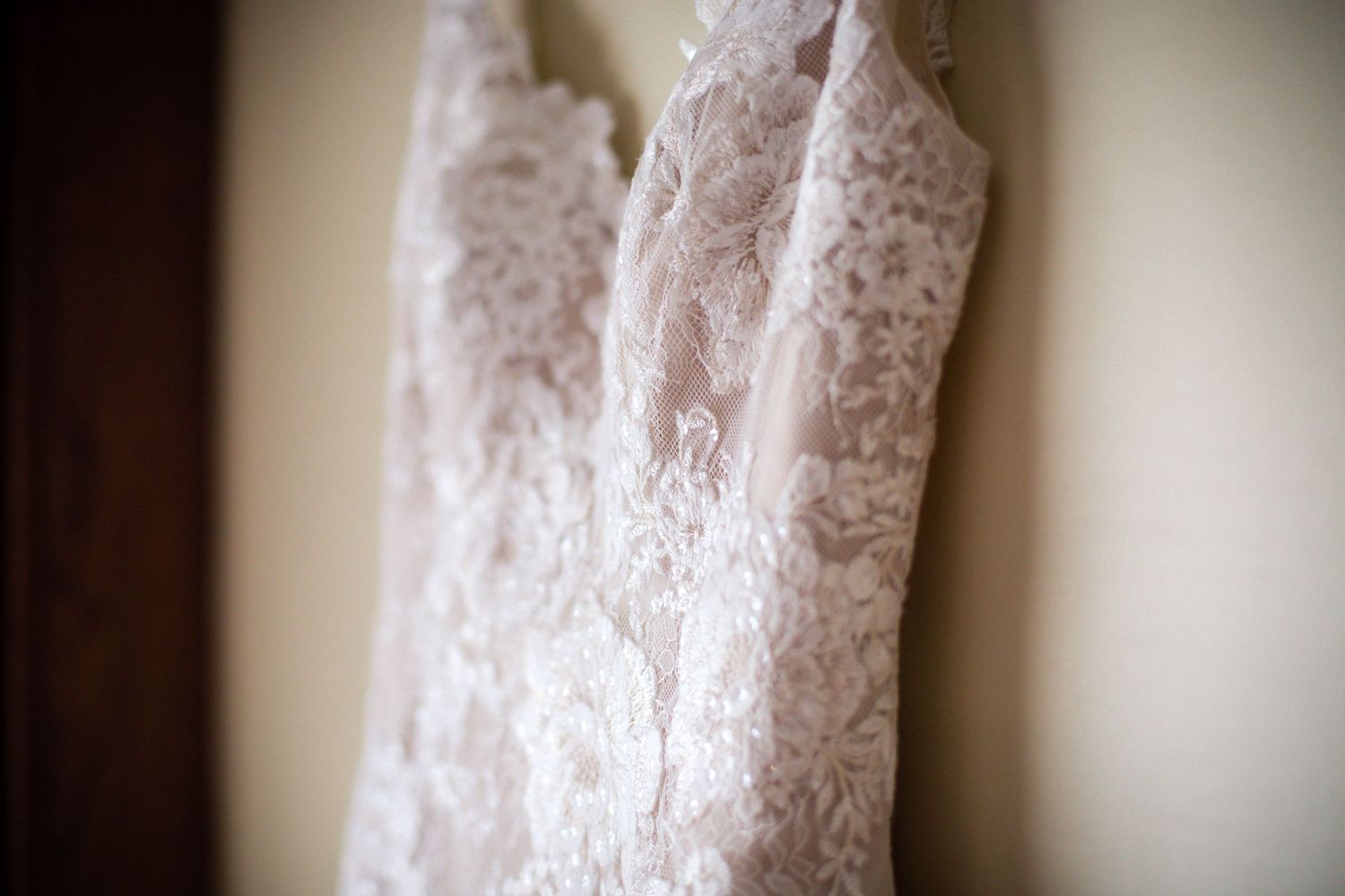Close-up of the delicate lace detail on the bride’s wedding dress