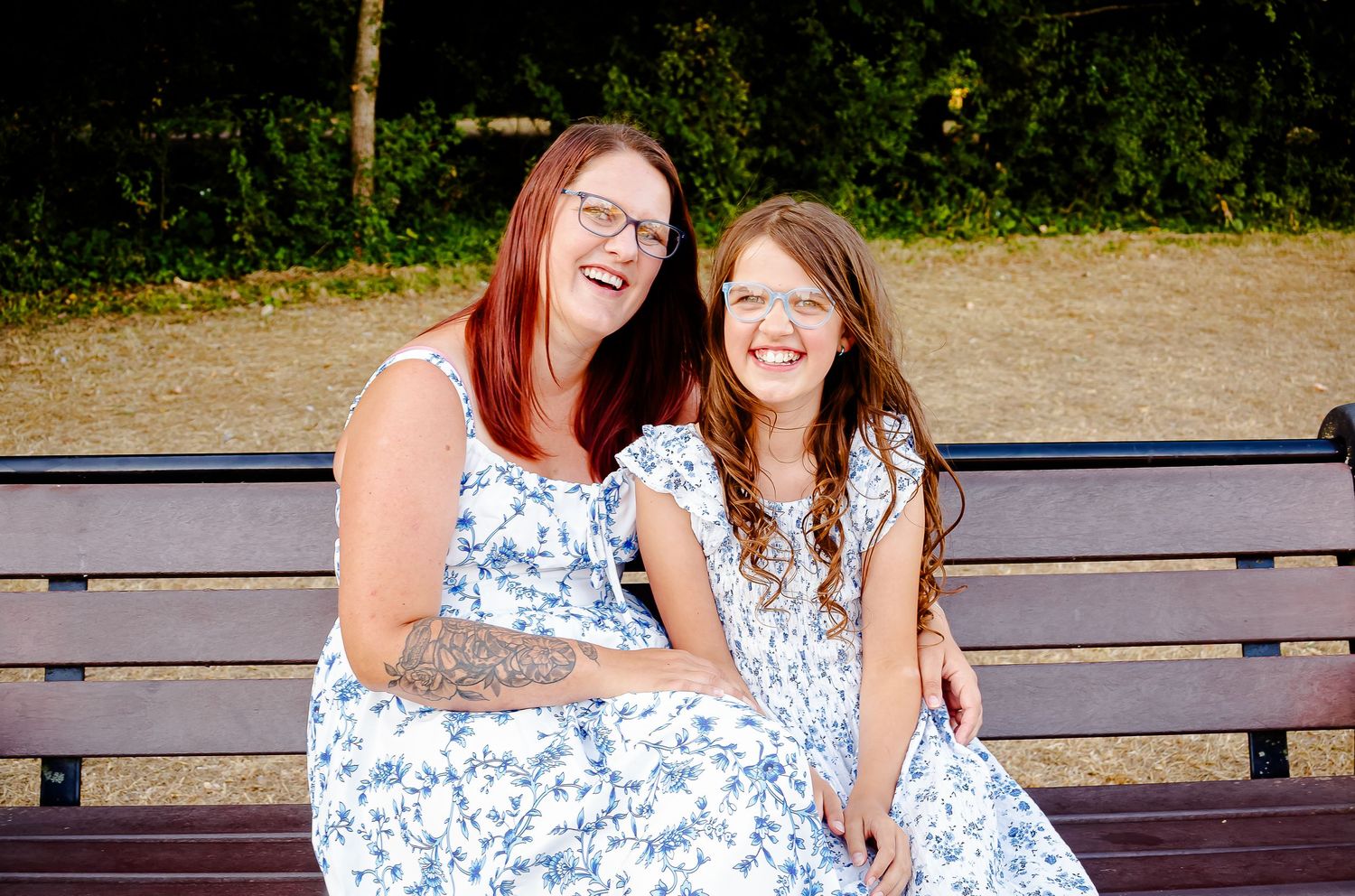 Mother and daughter laughing together on a bench at Cosmeston Lakes