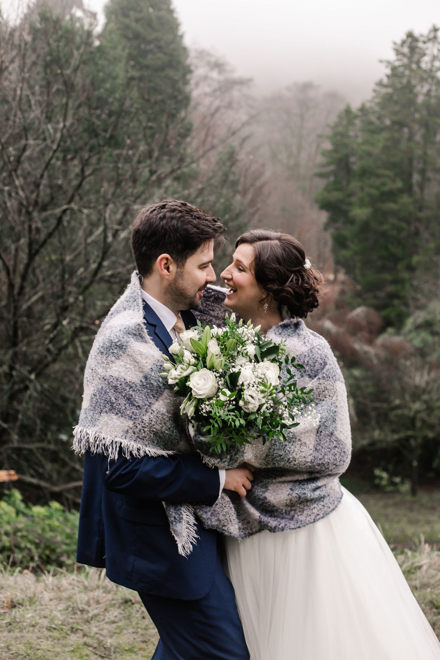 Bride and groom sharing a quiet kiss in the Craig y Nos Castle gardens