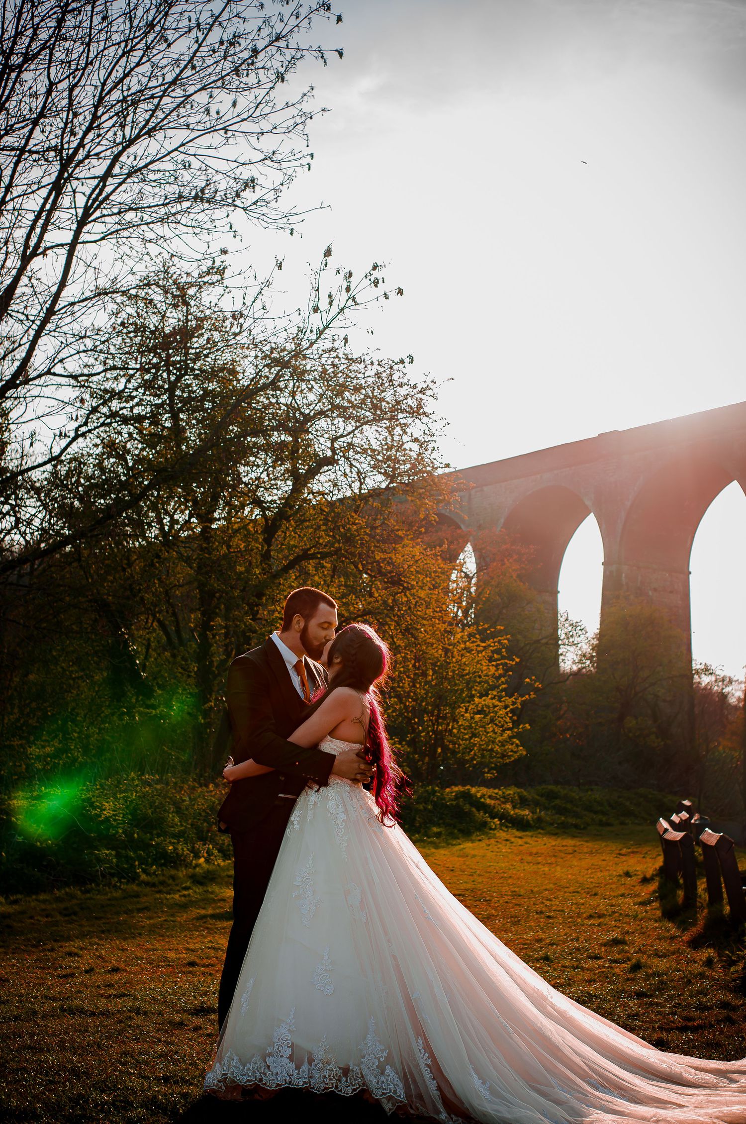 Newlyweds sharing a romantic moment near Porthkerry Park viaduct